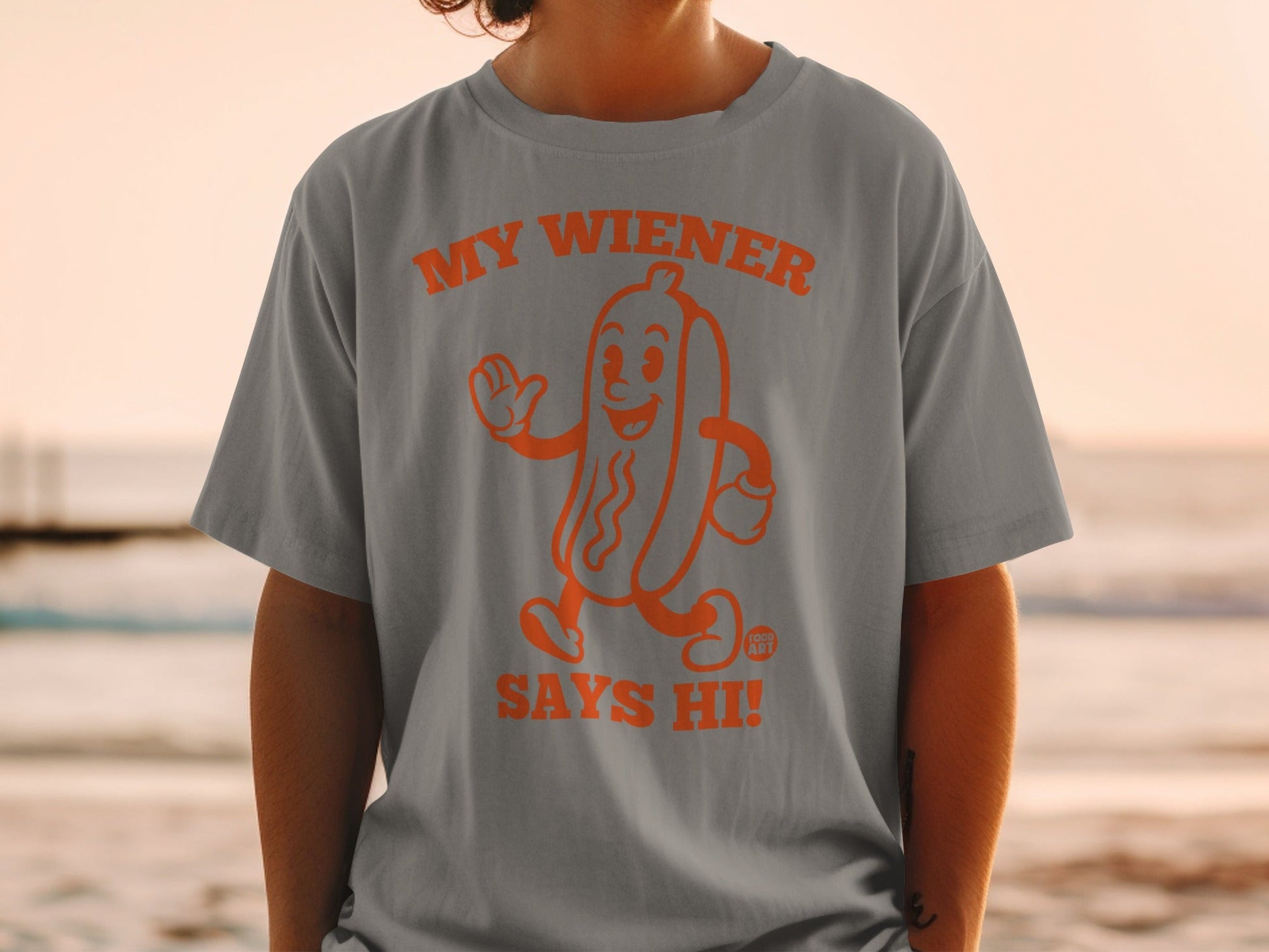 Gray t-shirt with orange hot dog graphic that says "My Wiener Says Hi!"