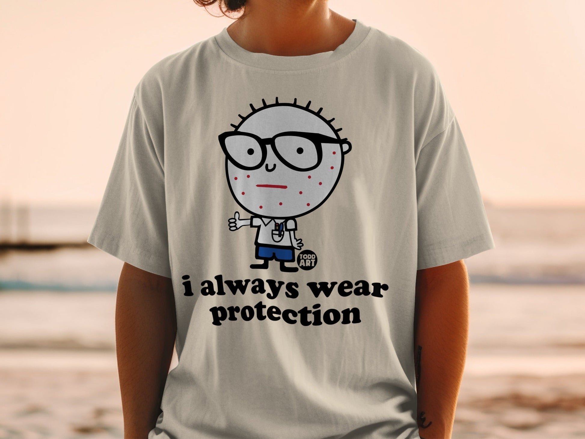 T-shirt with cartoon character wearing glasses and text "i always wear protection".