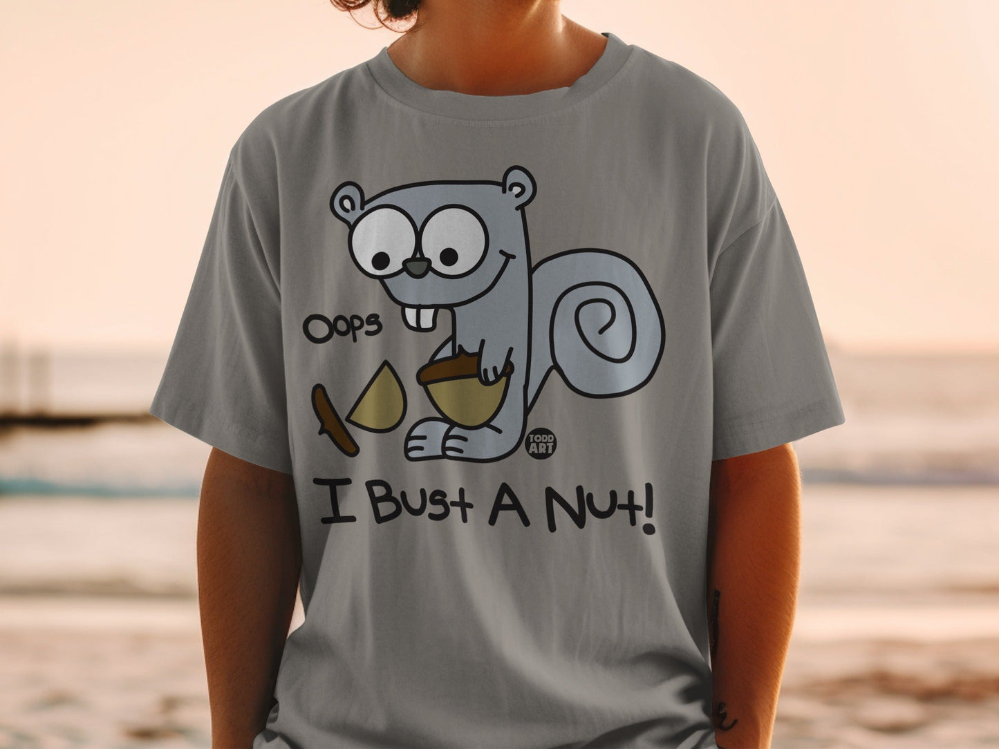 Gray t-shirt with cartoon squirrel saying "Oops I Bust a Nut!".