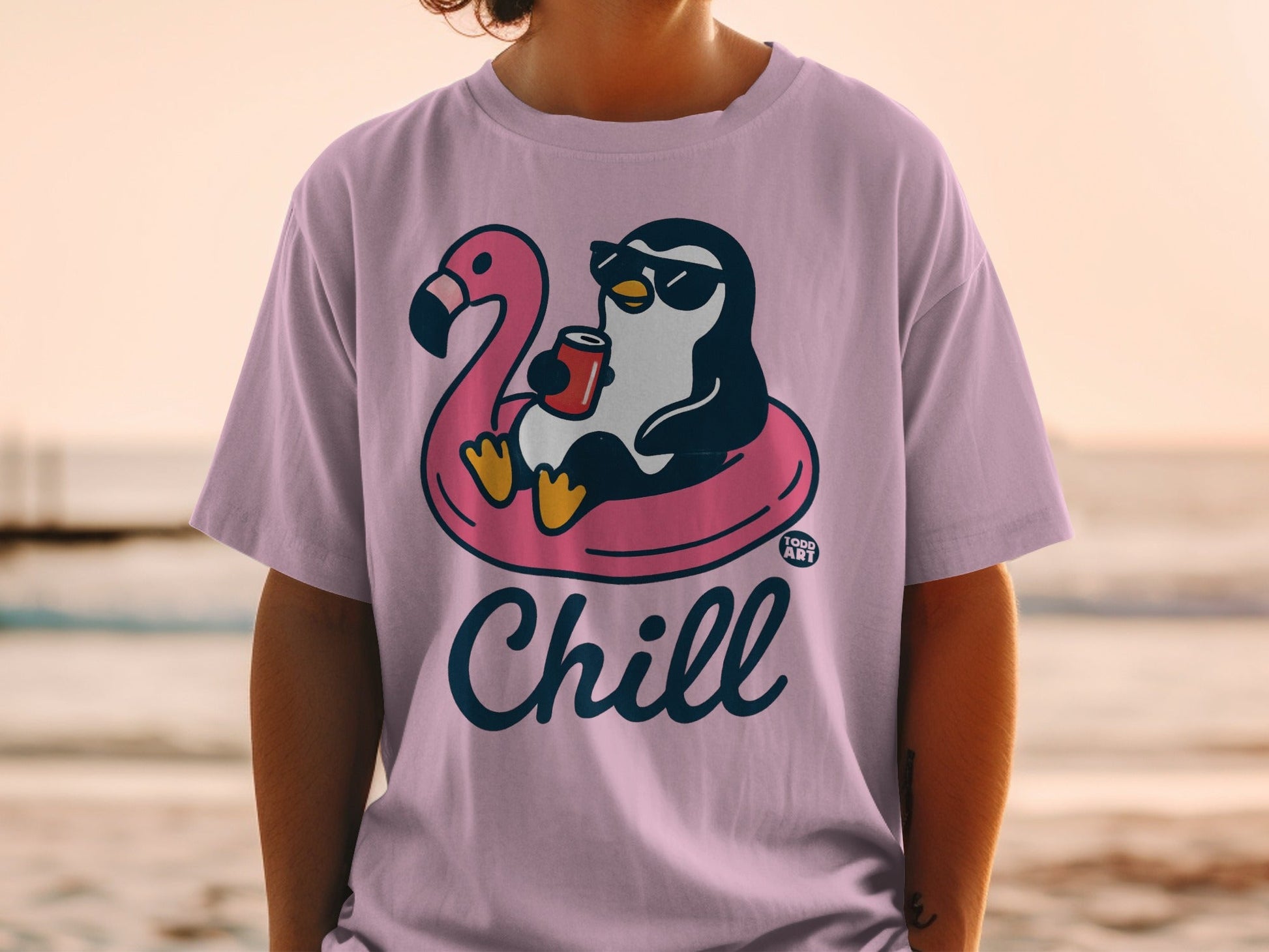 Penguin in sunglasses on flamingo float with drink, text "Chill" on pink shirt.
