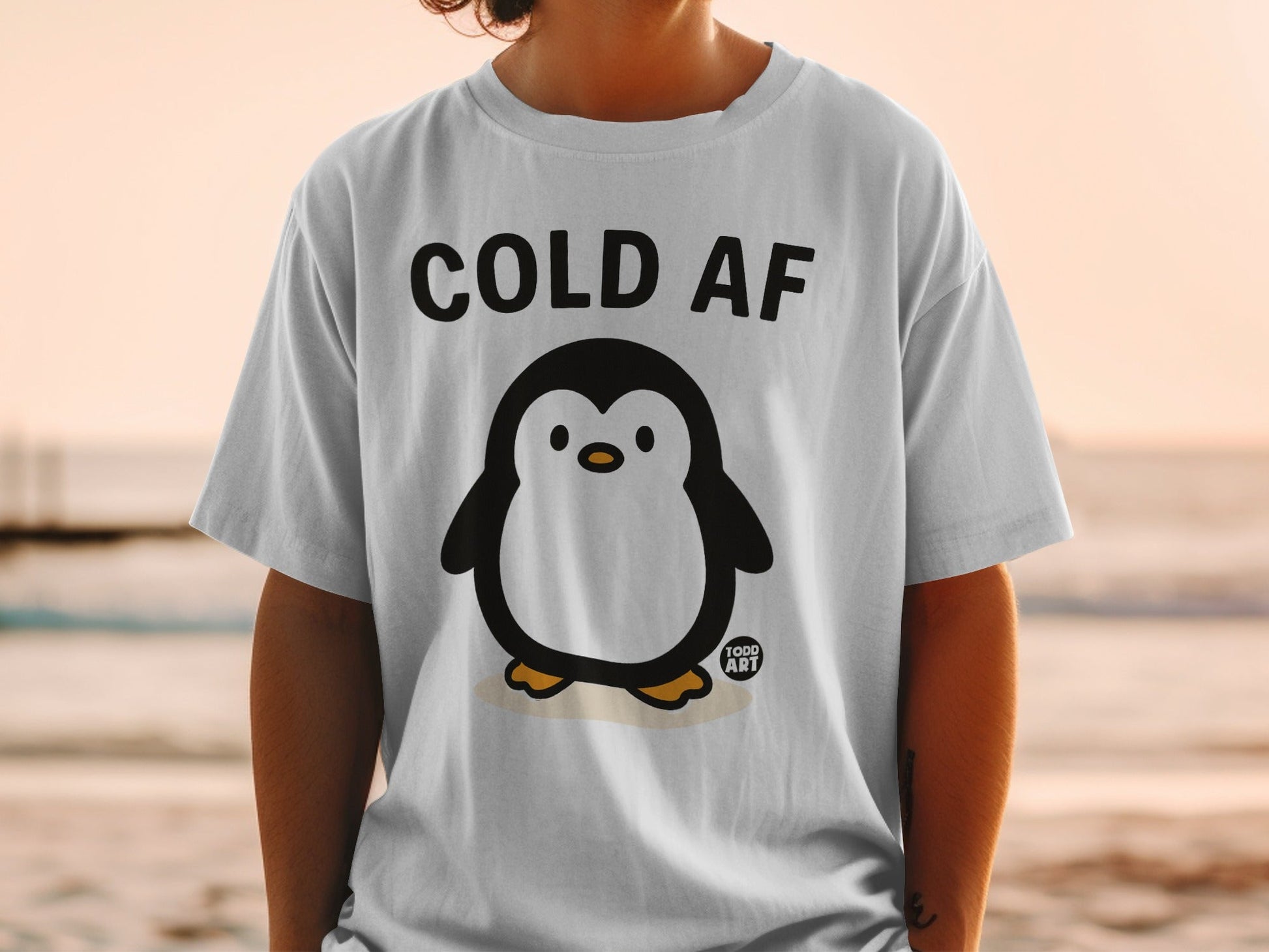 T-shirt with a cartoon penguin and "COLD AF" text.