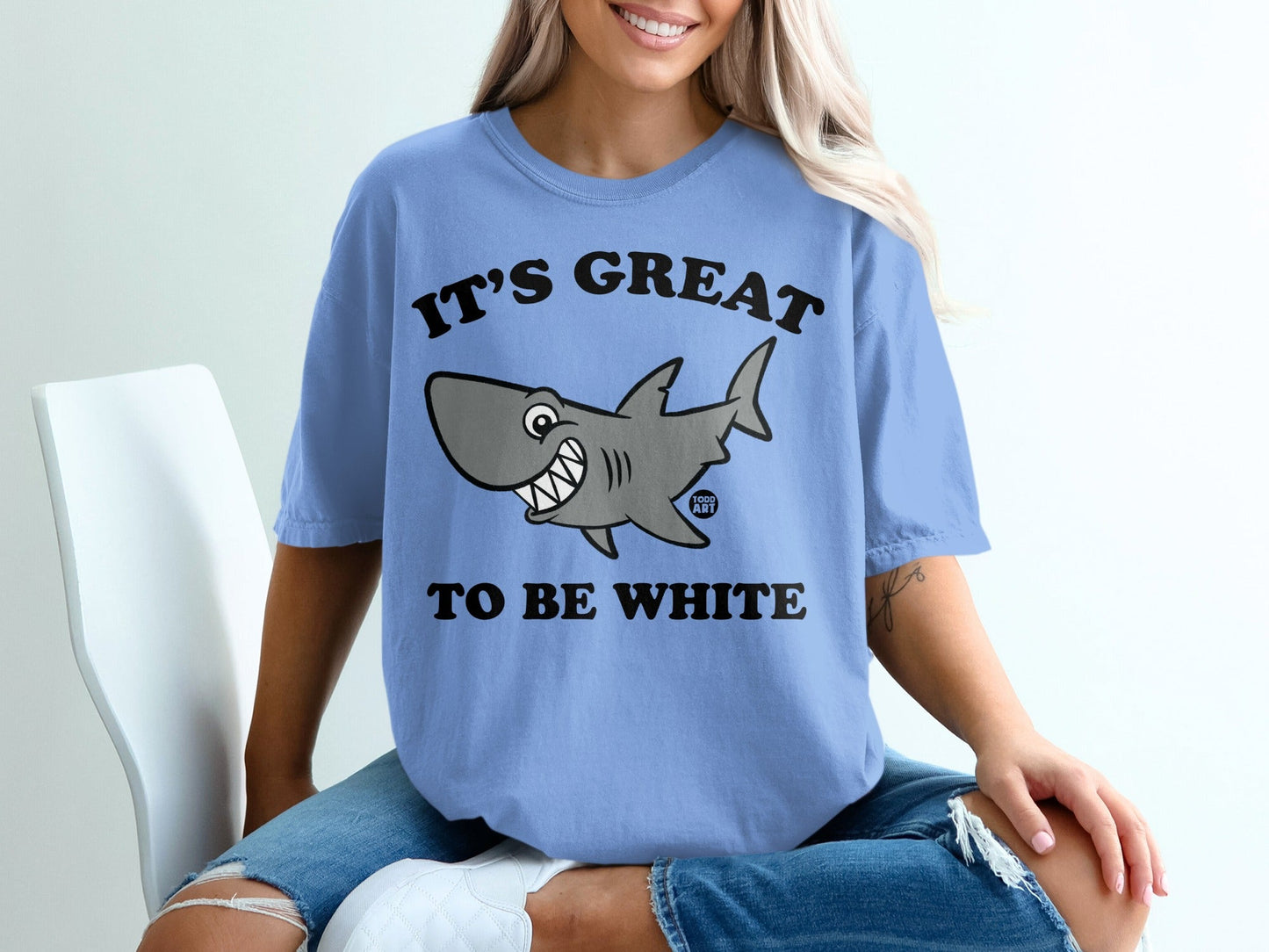 Blue t-shirt with "IT'S GREAT TO BE WHITE" and cartoon shark graphic.