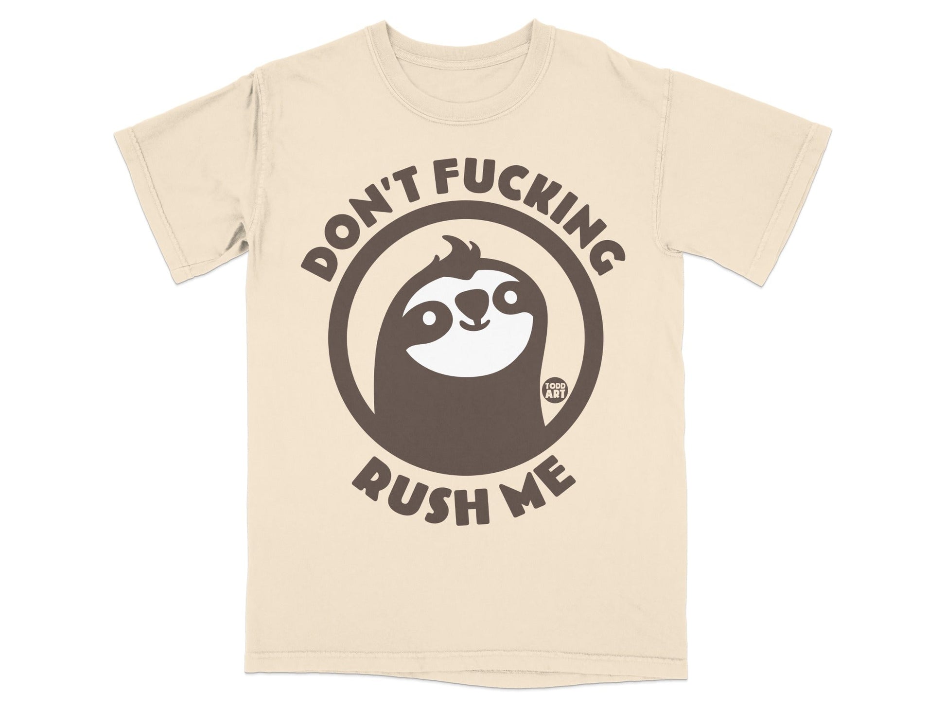 Cream t-shirt with a dark brown circular graphic of a sloth and the text "DON'T FUCKING RUSH ME".