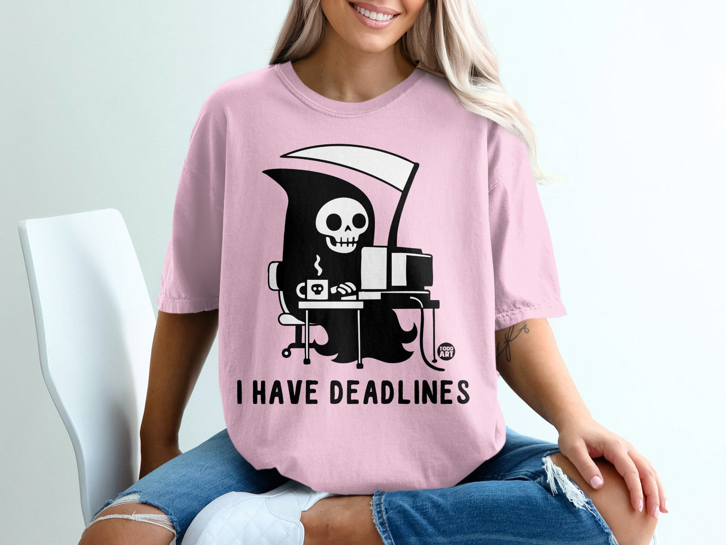 Pink t-shirt with grim reaper at a computer and text "I HAVE DEADLINES".