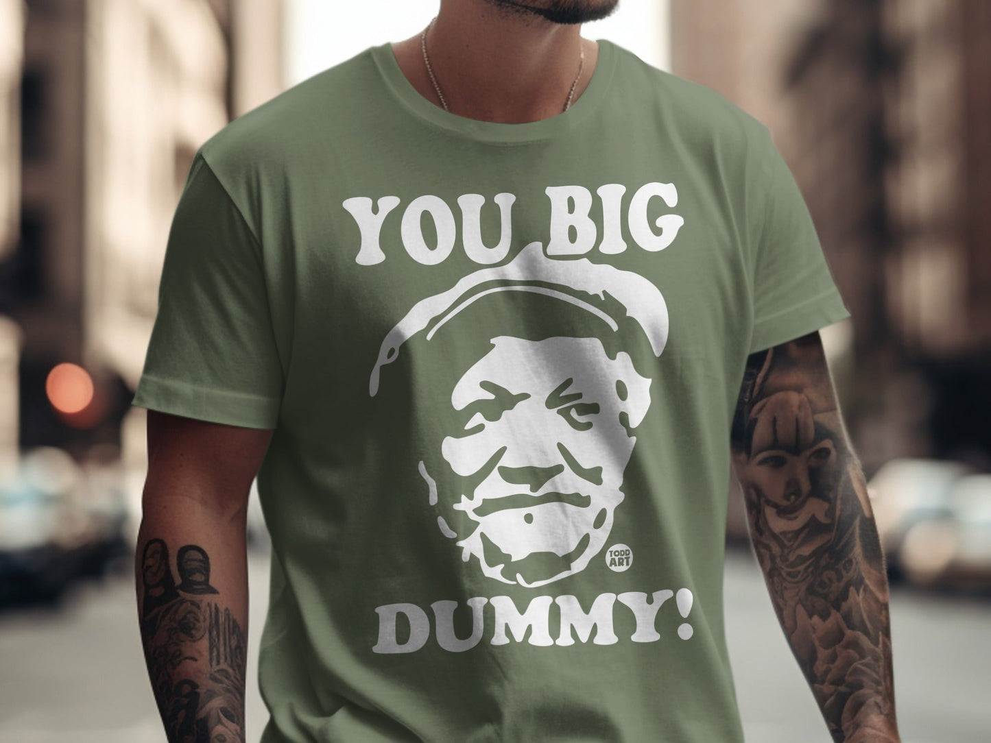 Green t-shirt with white "YOU BIG DUMMY!" text and a portrait.