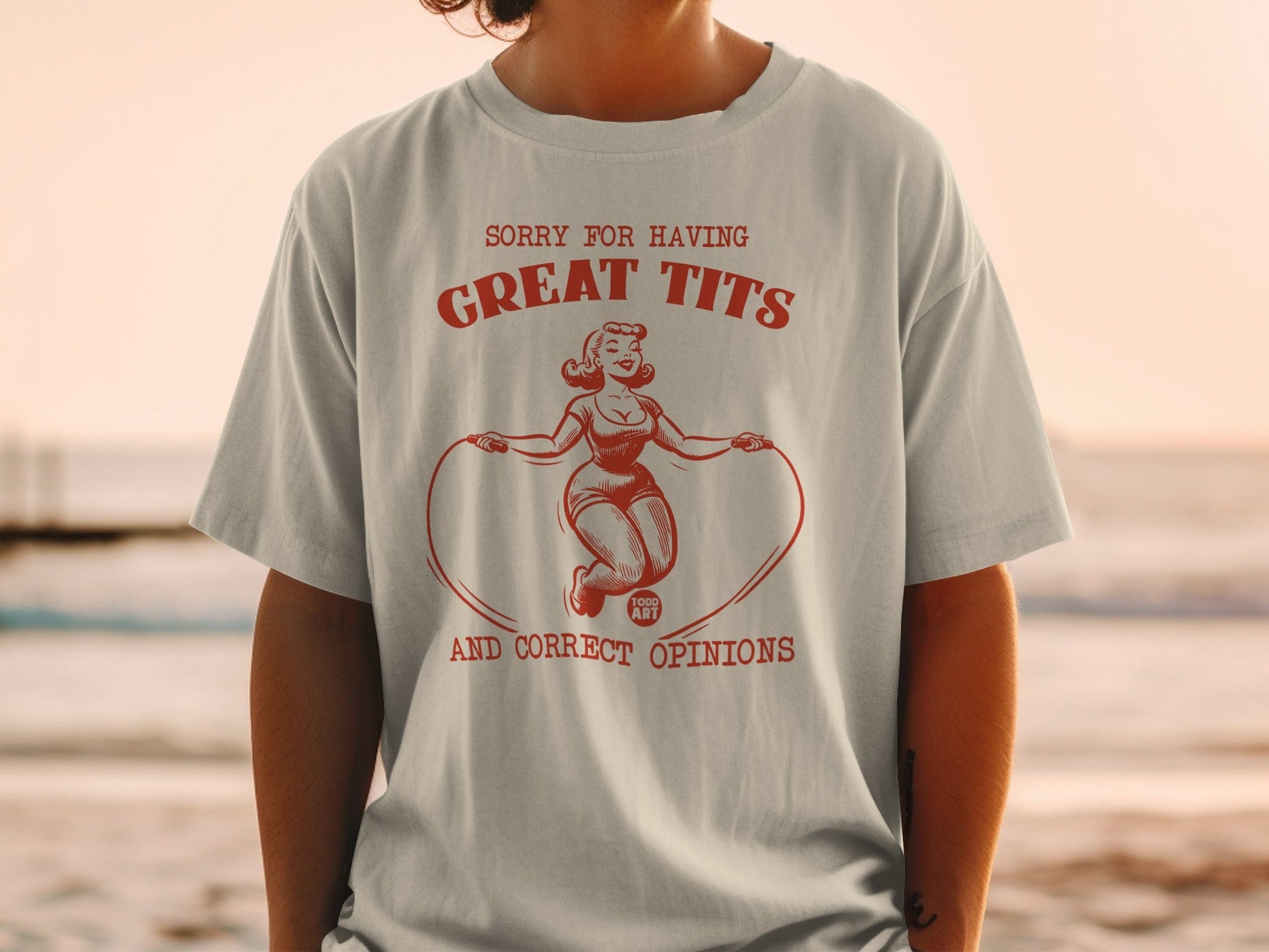 Graphic tee with woman jumping rope, text "SORRY FOR HAVING GREAT TITS AND CORRECT OPINIONS".