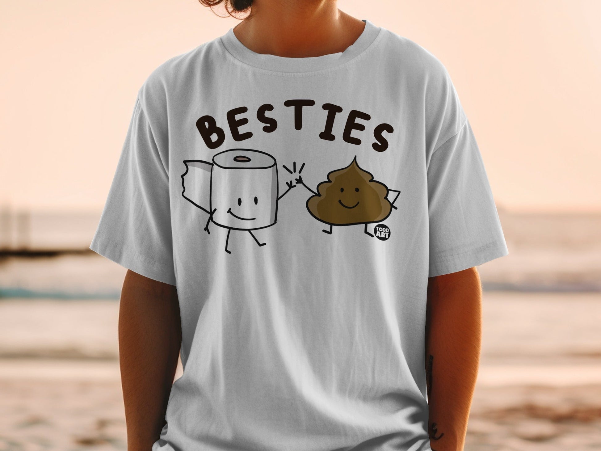 White t-shirt with cartoon toilet paper roll and poop characters giving a high five.