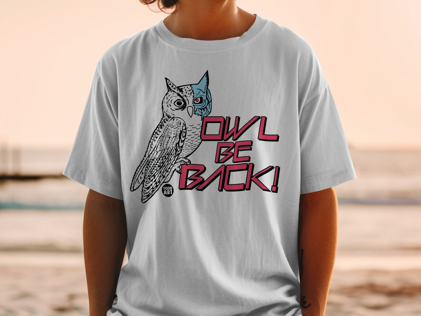White t-shirt with a stylized owl graphic and "OWL BE BACK!" text.