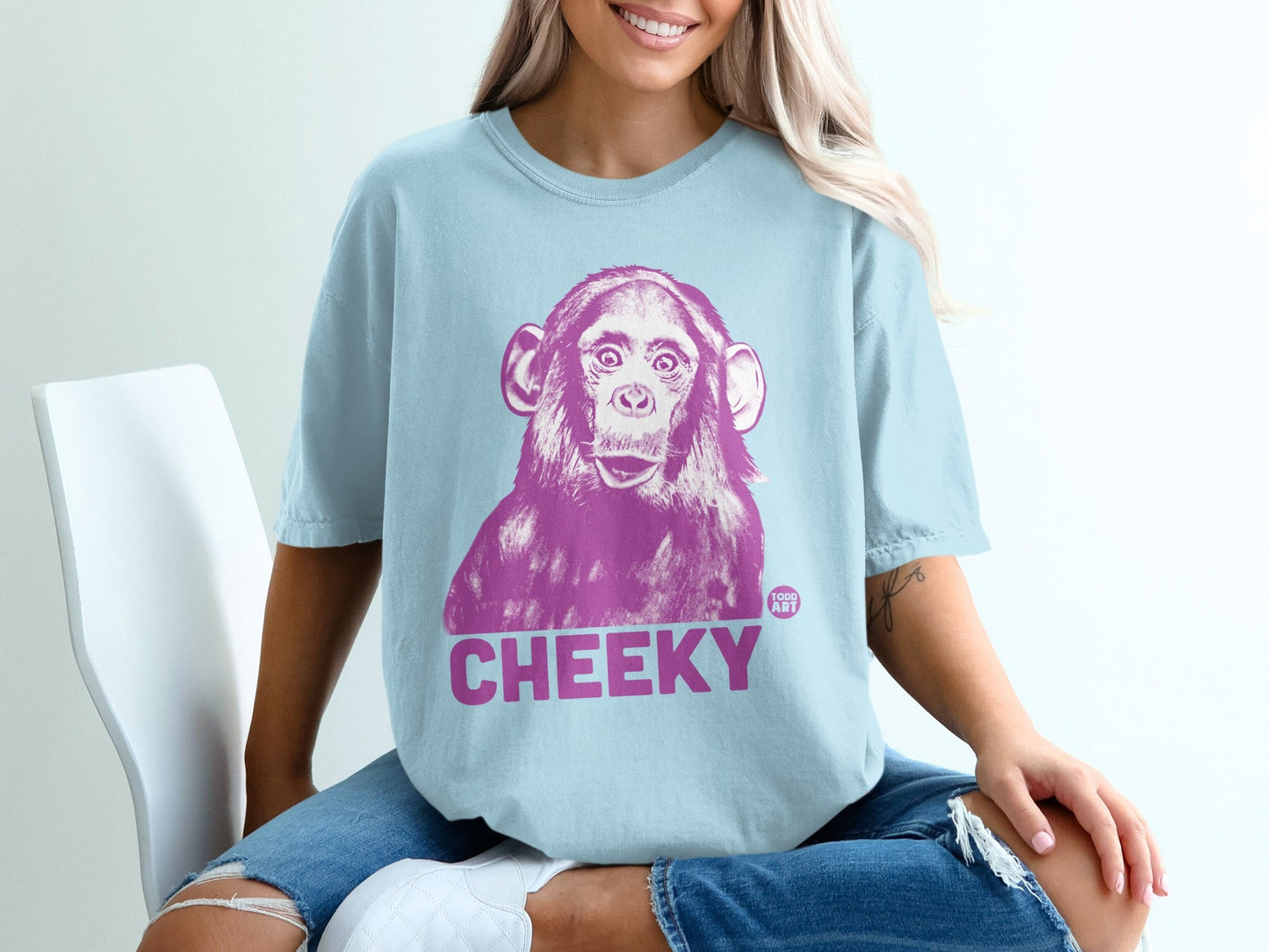Light blue t-shirt with a purple monkey graphic and "CHEEKY" text.