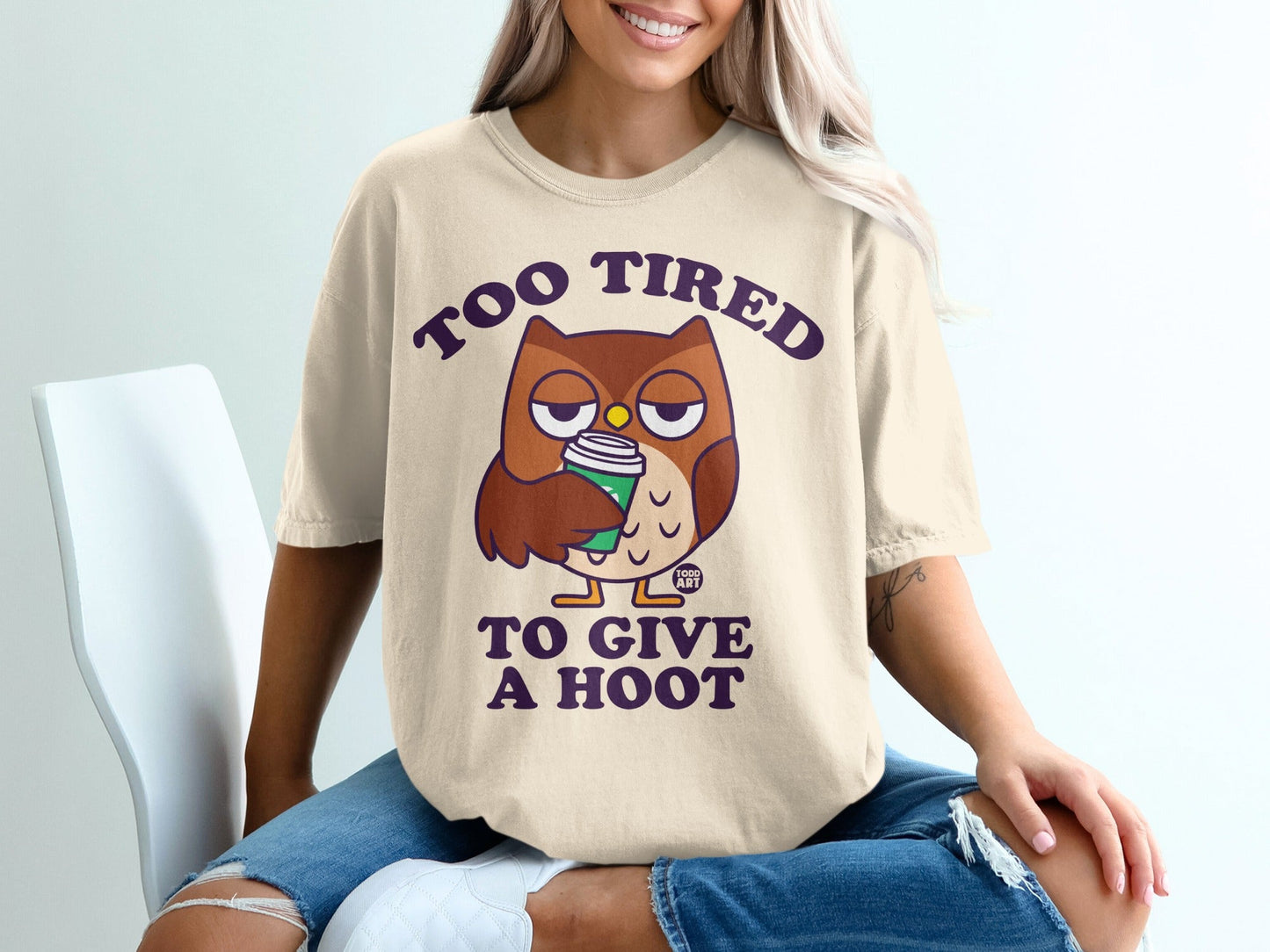 T-shirt with cartoon owl saying "Too tired to give a hoot" holding coffee.