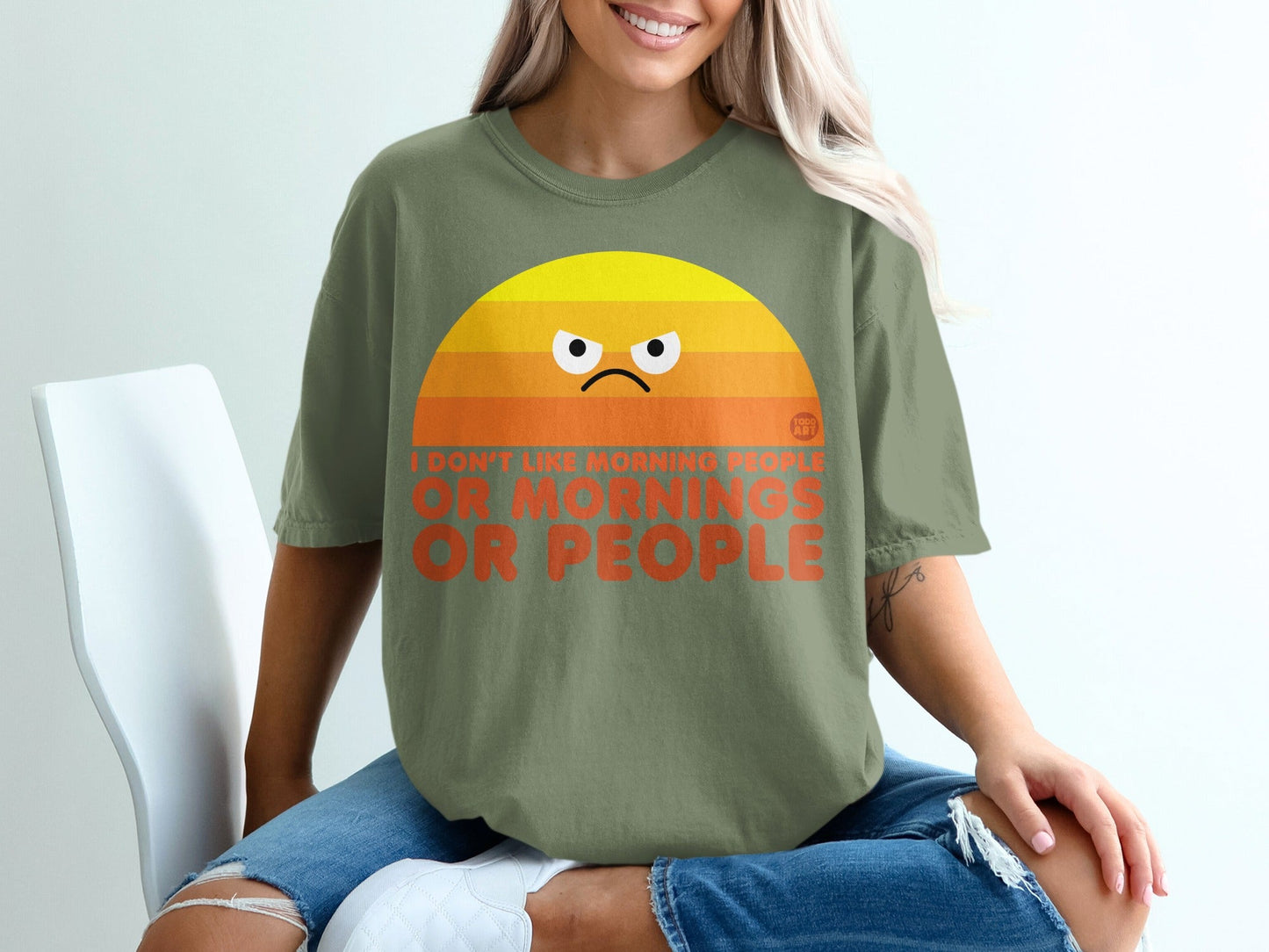Green t-shirt with a grumpy sunrise graphic and text: "I don't like morning people or people."