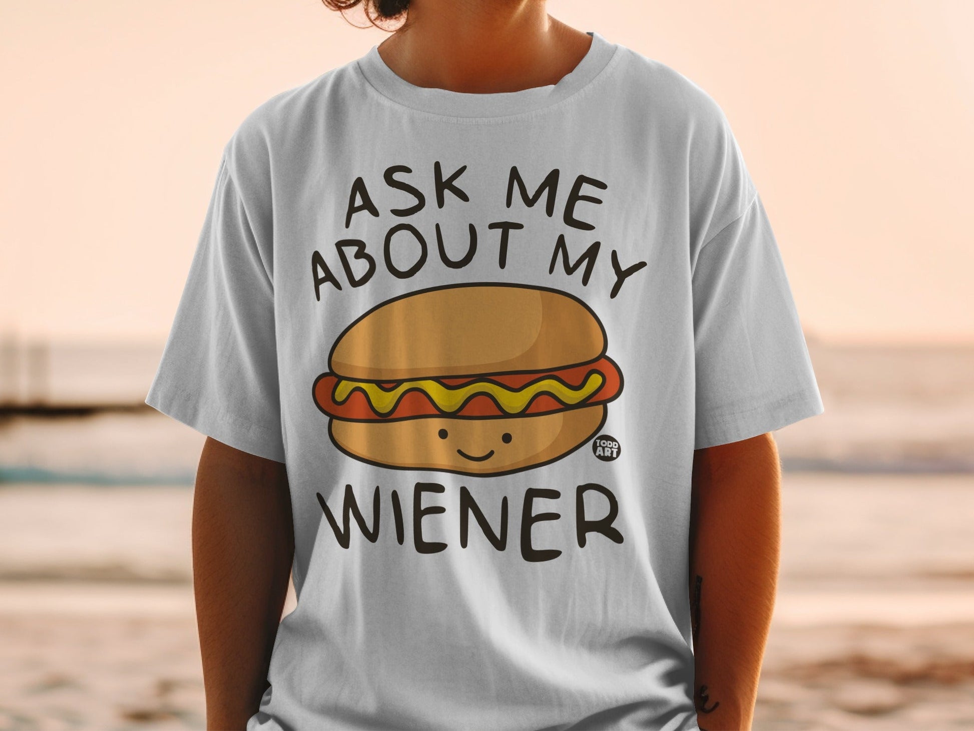 White t-shirt with "Ask Me About My Wiener" and a smiling hot dog graphic.