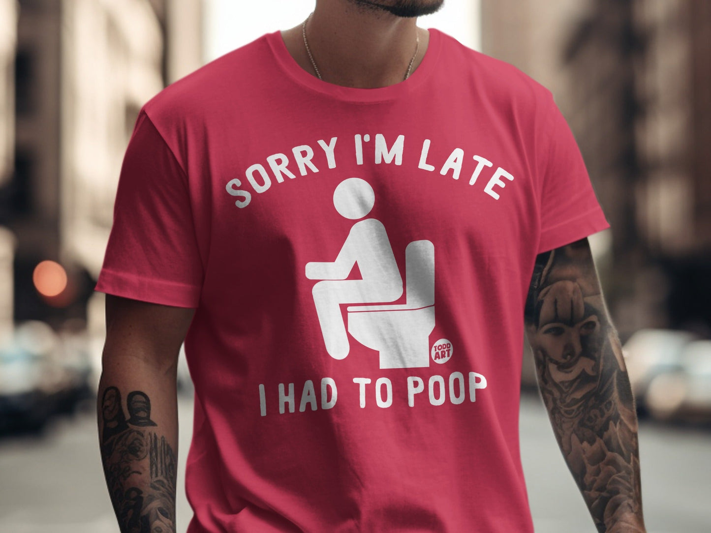 Red t-shirt with "Sorry I'm late I had to poop" graphic.