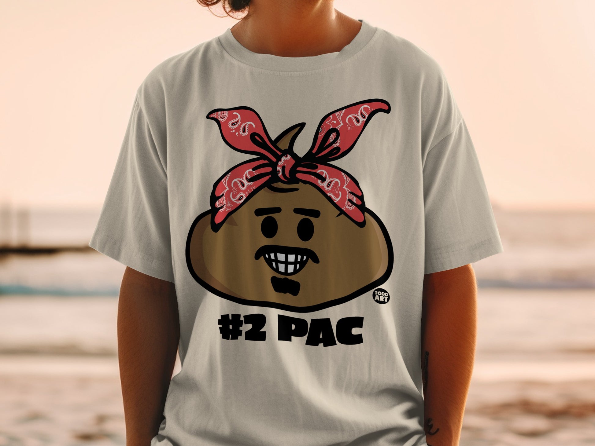 T-shirt with a cartoon brown face, red bandana, and #2 PAC text.