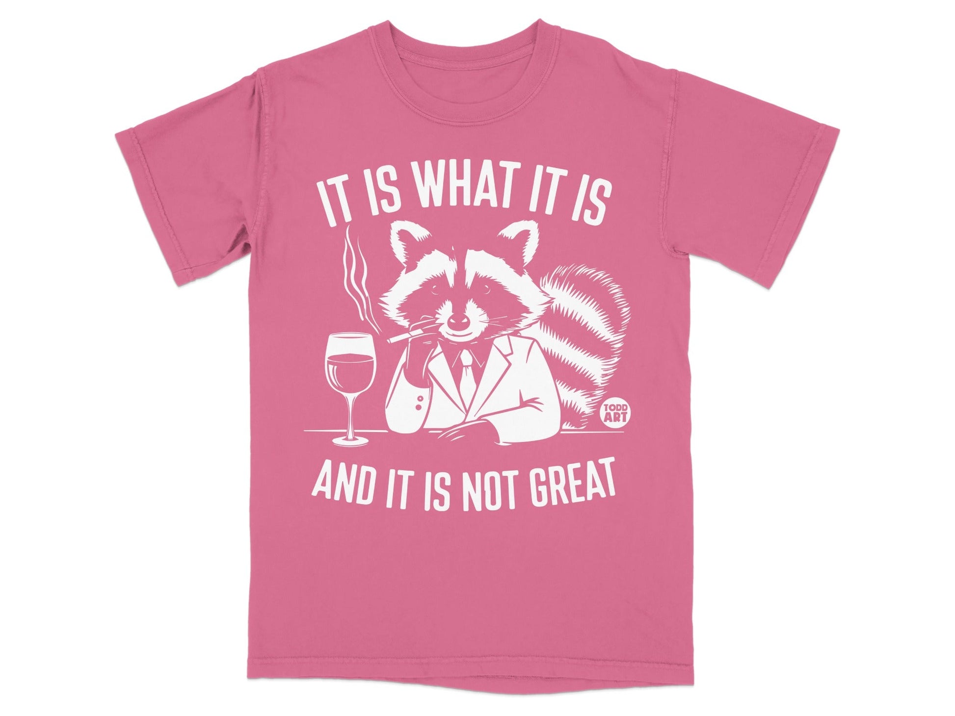 Pink t-shirt with a smoking raccoon in a suit saying "It is what it is and it is not great."