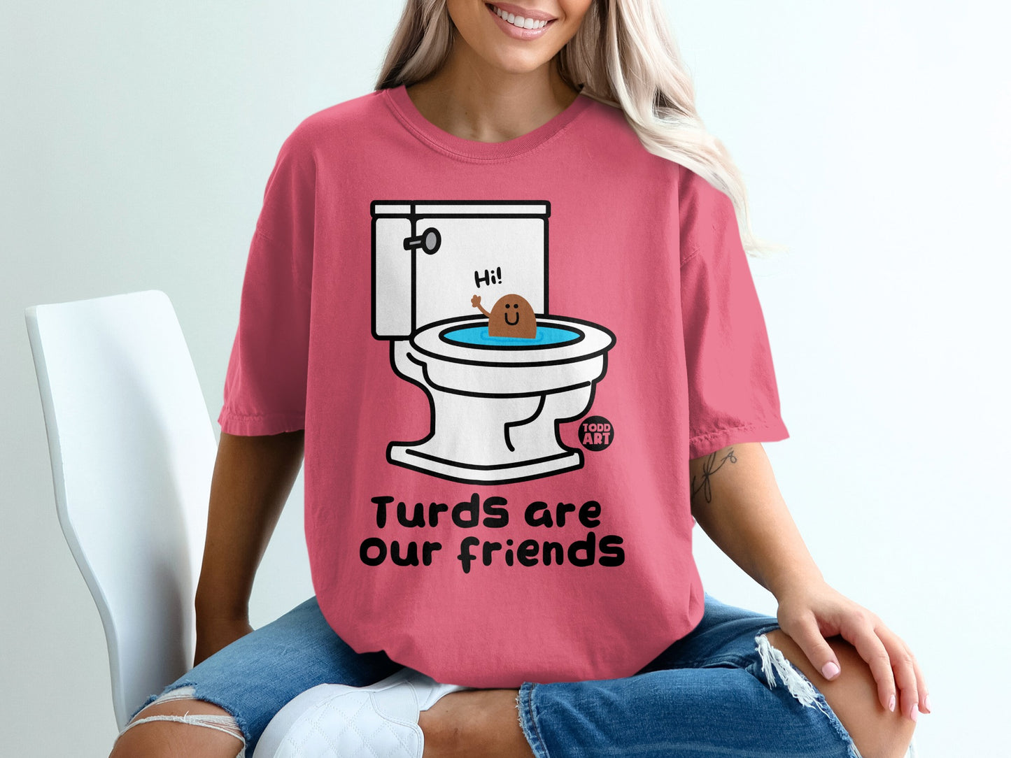 Pink t-shirt with toilet graphic and text "Turds are our friends".