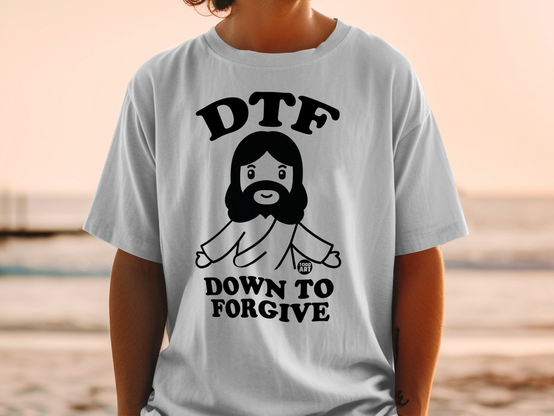 T-shirt with cartoon Jesus and "DTF DOWN TO FORGIVE" text.