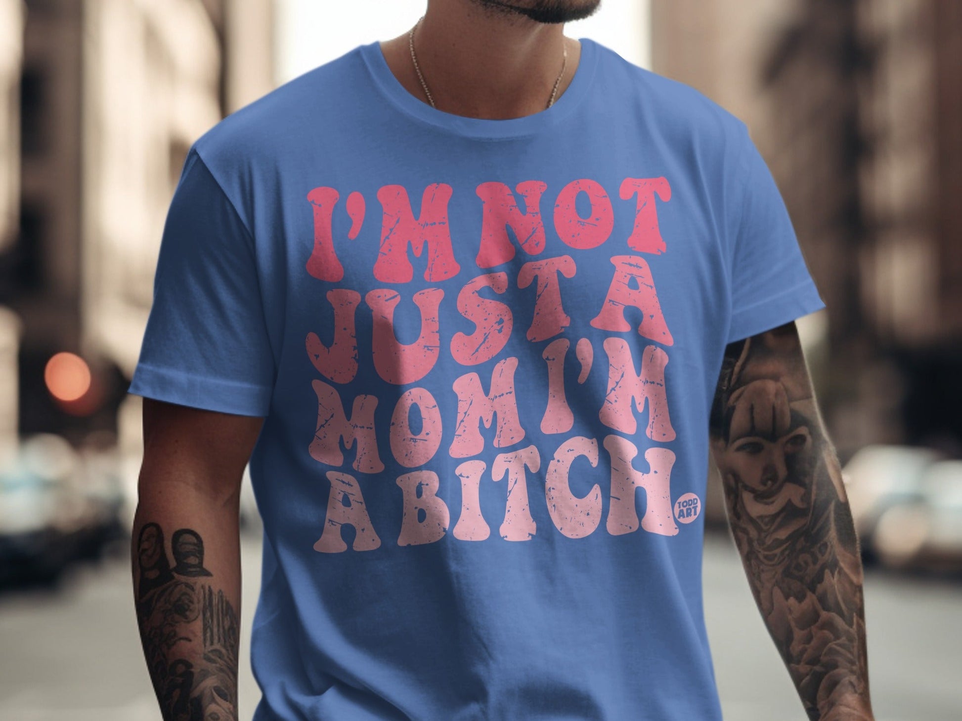 Blue t-shirt with pink distressed text reading "I'M NOT JUST A MOM I'M A BITCH".