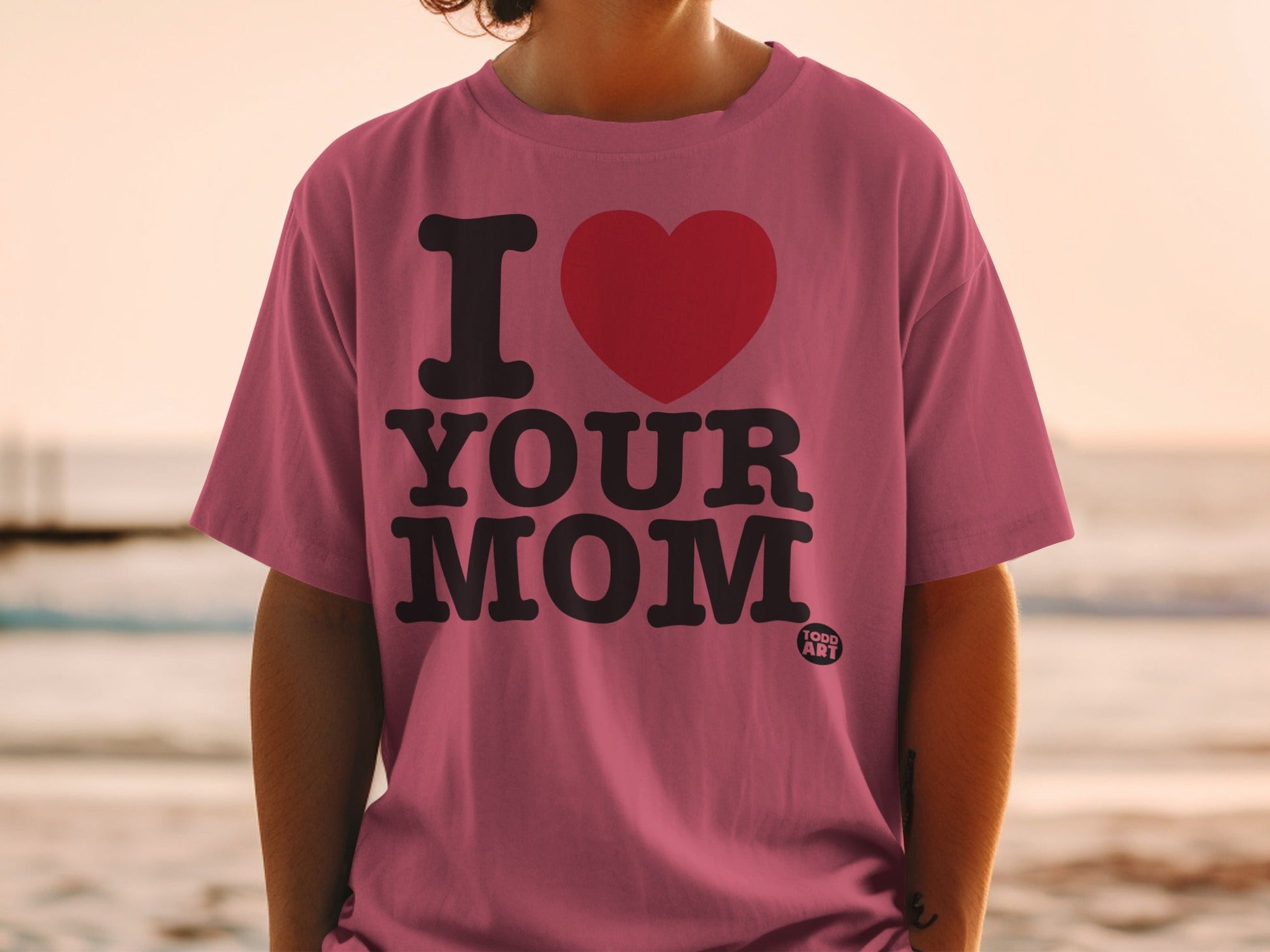 Pink t-shirt with "I ‚ù§Ô∏è YOUR MOM" text and a small "TOGO ART" logo.