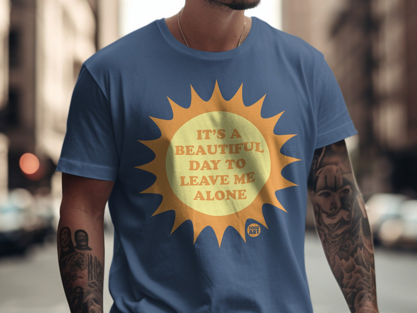 Blue t-shirt with yellow sun graphic and text "It's a beautiful day to leave me alone."