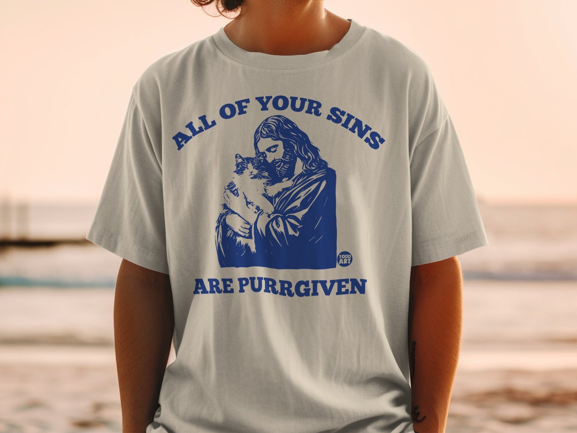 Jesus holding a cat with "All of Your Sins Are Purr-given" text.