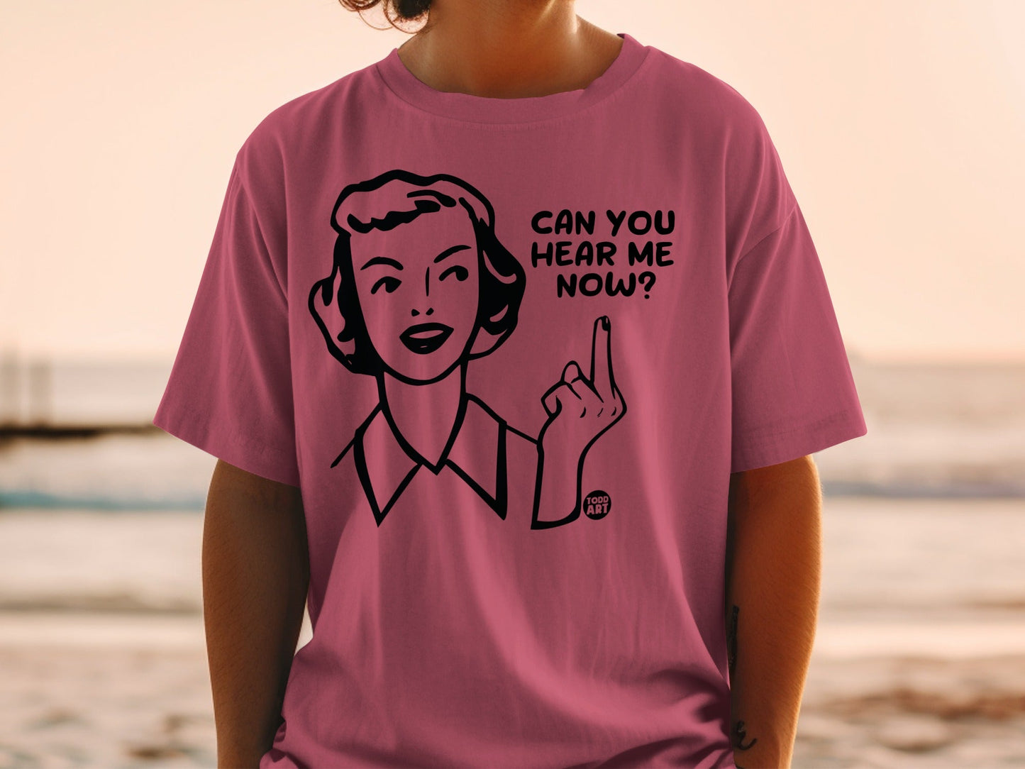 Pink t-shirt with cartoon woman pointing finger and text "CAN YOU HEAR ME NOW? FOOD ART".