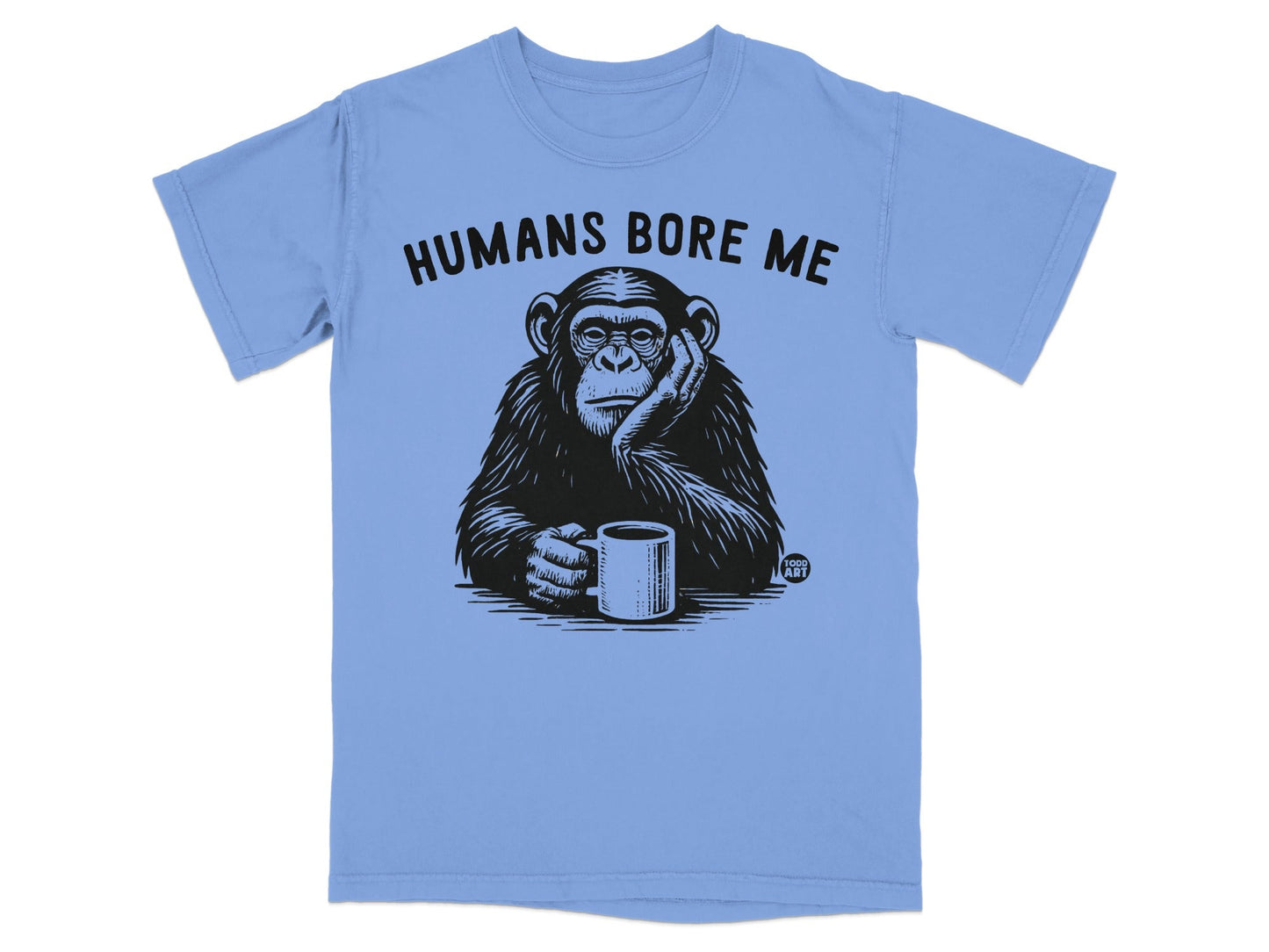 Chimpanzee wearing t-shirt with text "Humans Bore Me" and holding coffee mug.