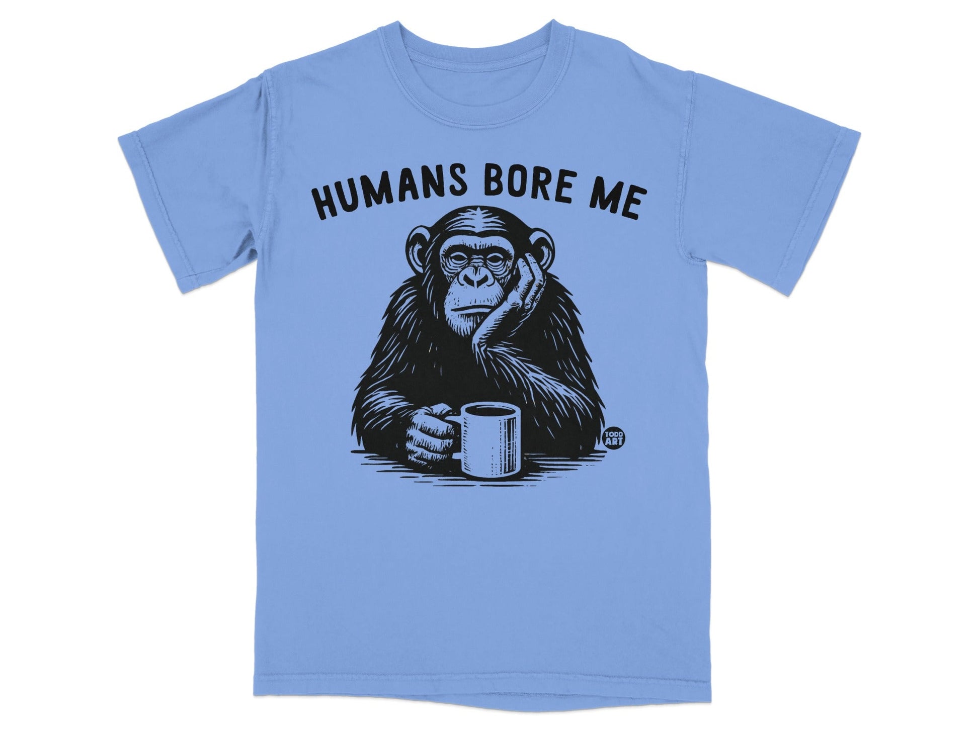 Chimpanzee wearing t-shirt with text "Humans Bore Me" and holding coffee mug.