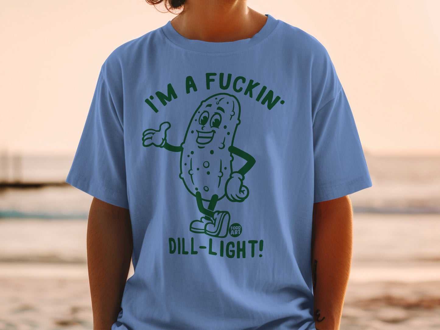 Blue t-shirt with cartoon pickle graphic saying "I'm a fuckin' dill-light!"