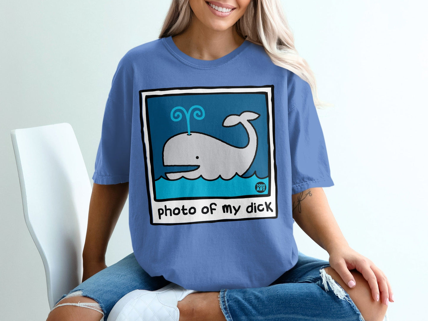 Blue t-shirt with cartoon whale illustration and text "photo of my dick".
