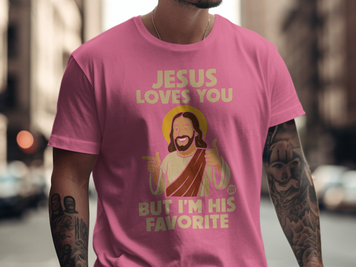 Pink t-shirt with "Jesus loves you but I'm his favorite" and cartoon Jesus.