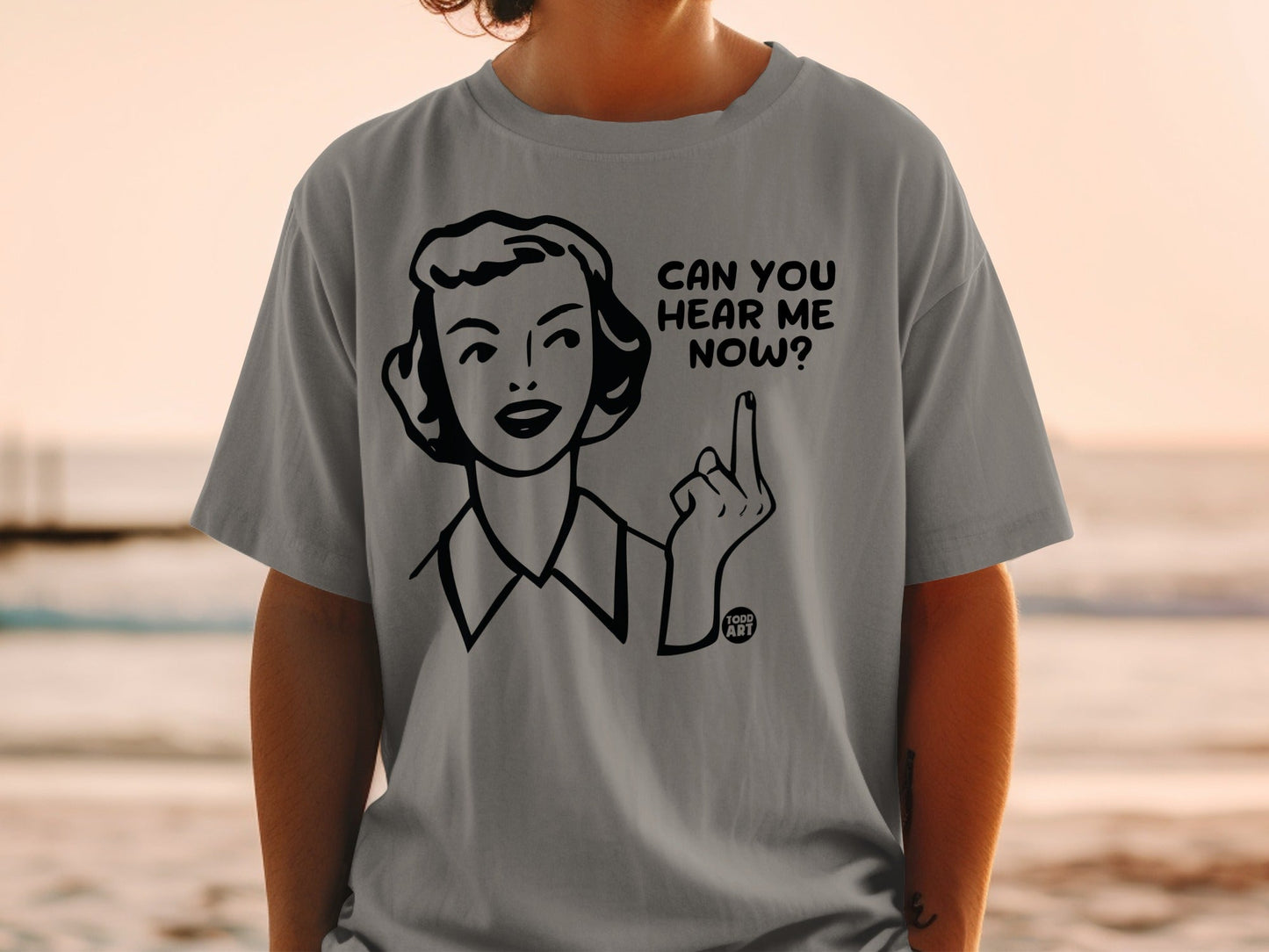 Gray t-shirt with cartoon woman pointing and text "CAN YOU HEAR ME NOW?"