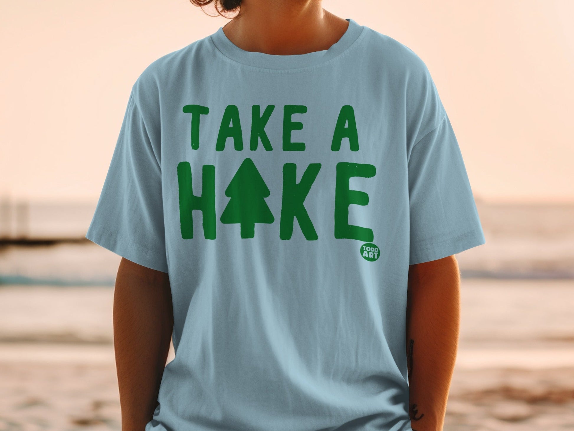 Light blue t-shirt with "Take a Hake" and a Christmas tree graphic.