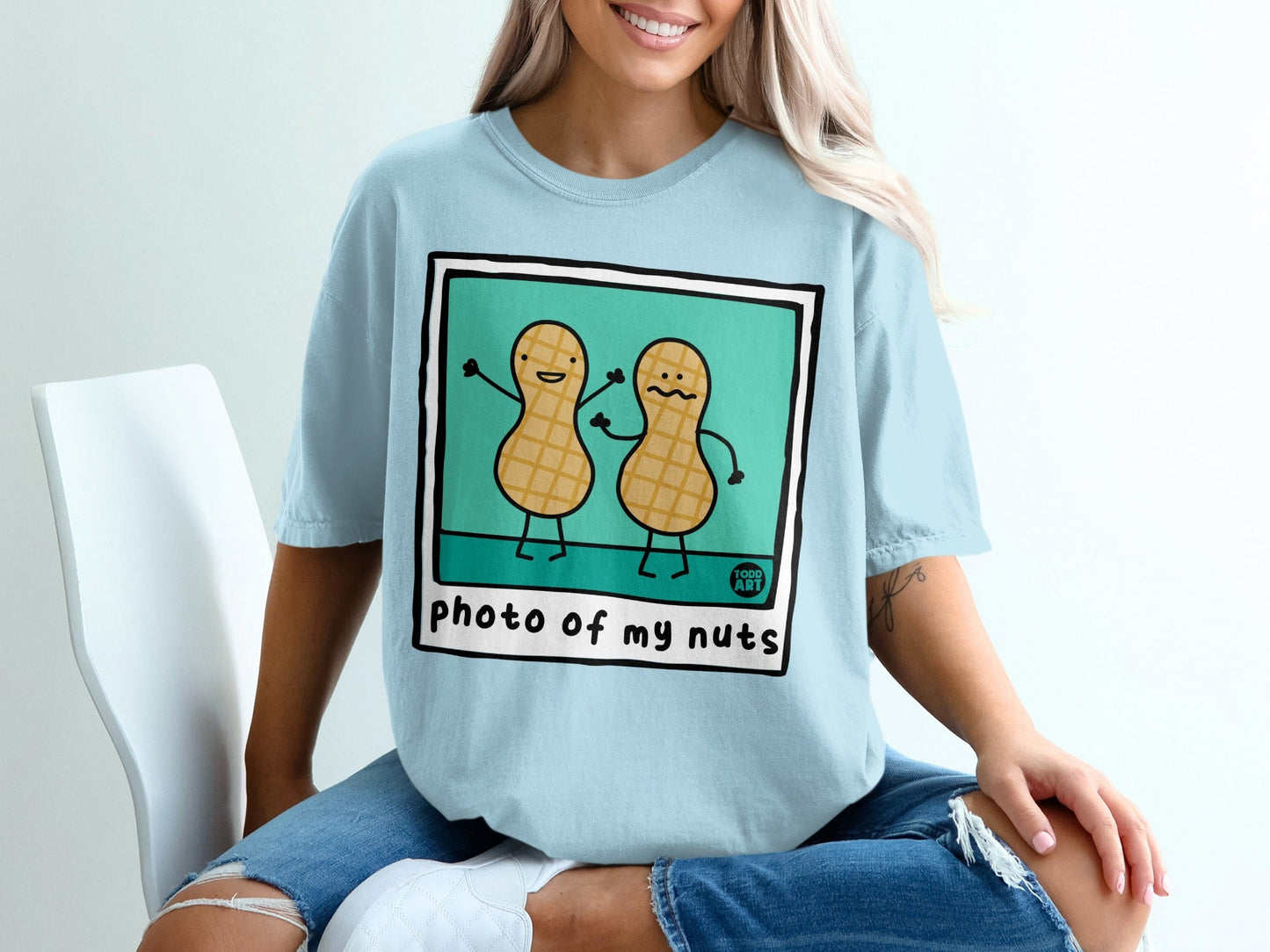 Light blue t-shirt with cartoon peanuts saying "photo of my nuts".