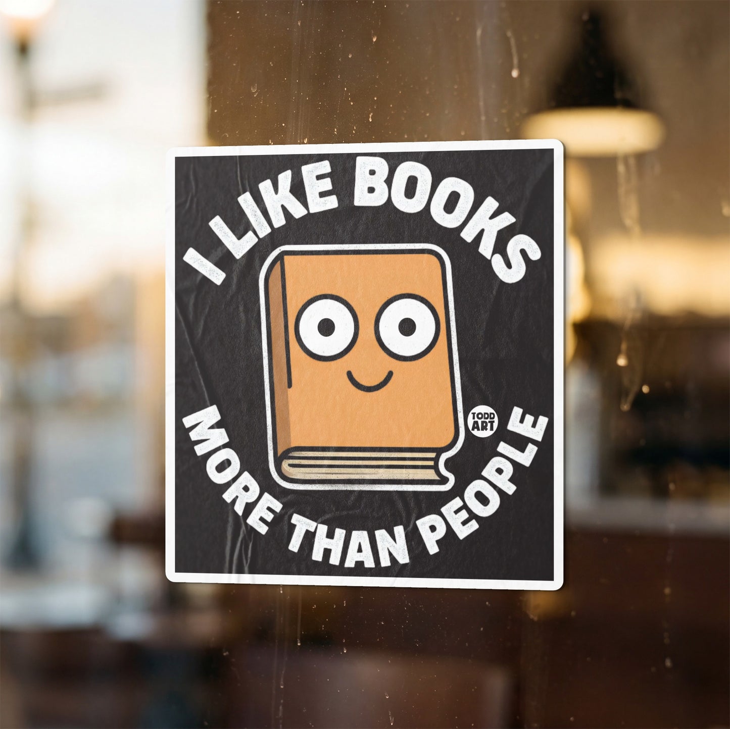 "I like books more than people" sticker with a cartoon book illustration.