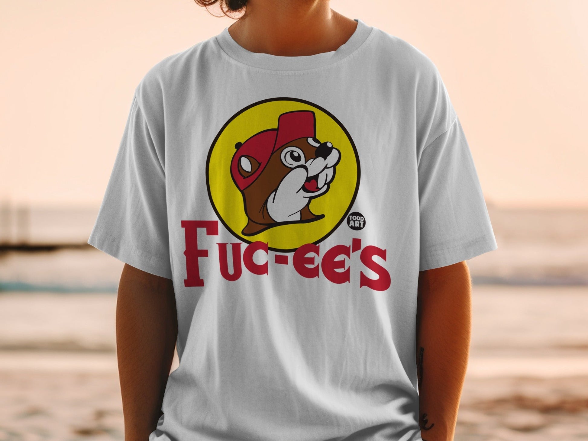 Buc-ee's logo on a white t-shirt worn by a person.