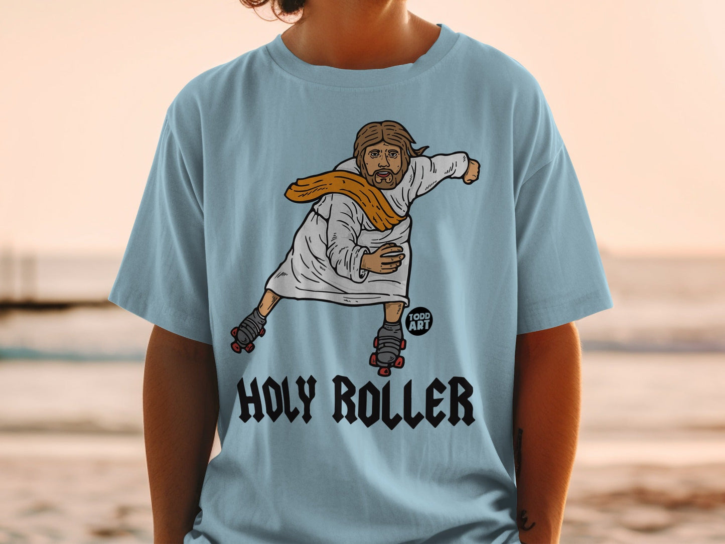 Jesus on roller skates wearing an orange sash, "HOLY ROLLER" text.