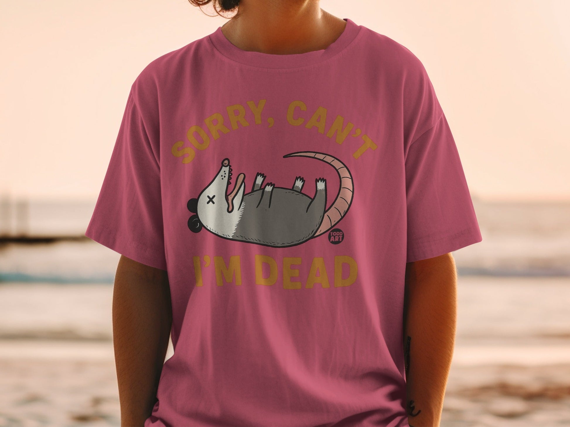 T-shirt with cartoon opossum and text "Sorry, can't I'm dead".