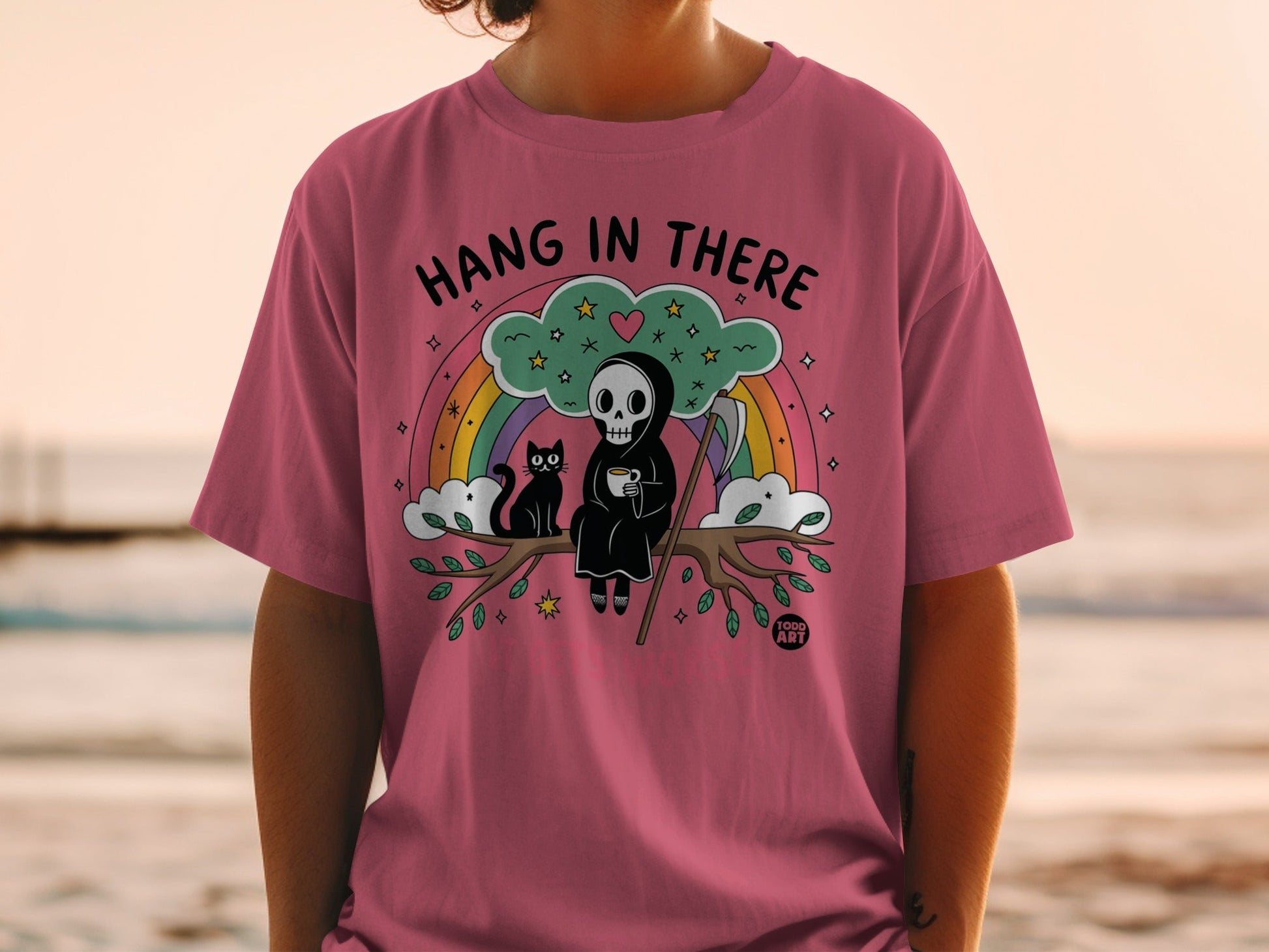 Grim reaper cat and rainbow design with text "Hang in There".