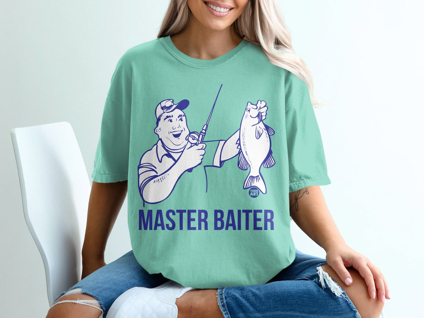 T-shirt with graphic of a cartoon fisherman holding a fish, text "MASTER BAITER".