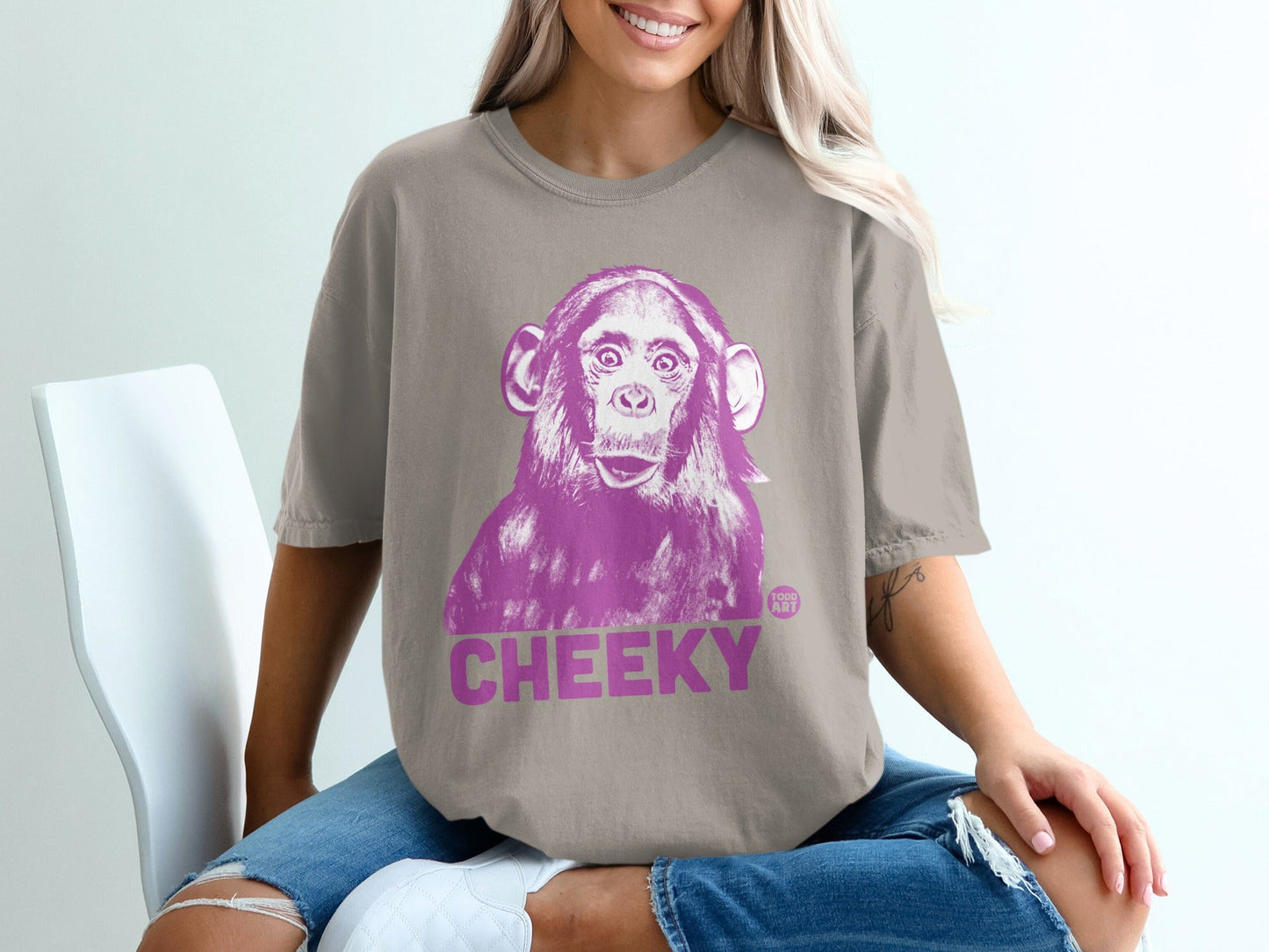 T-shirt with a pink graphic of a chimpanzee and the word "CHEEKY".