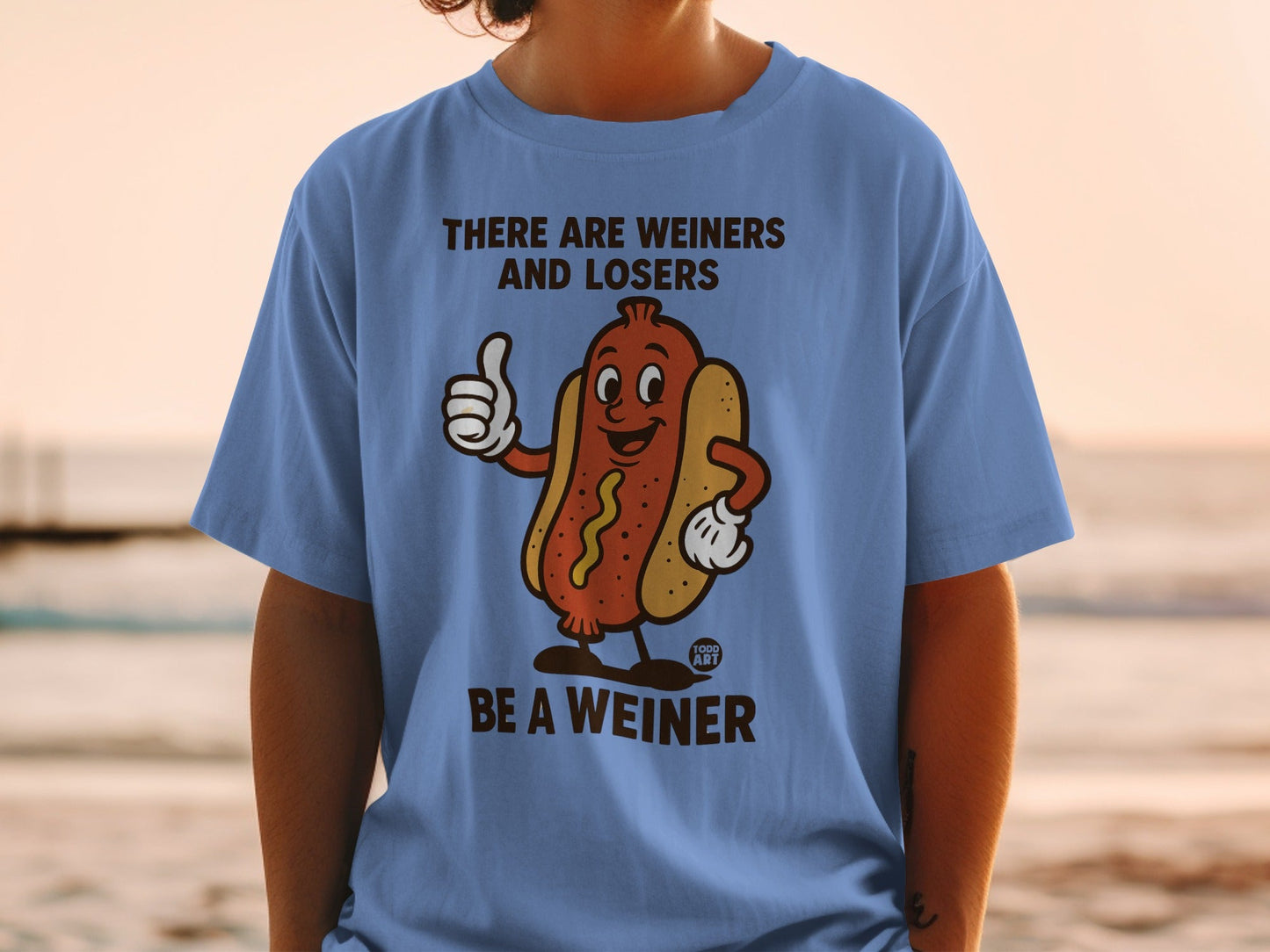 Blue t-shirt with cartoon hot dog giving a thumbs up and text "THERE ARE WEINERS AND LOSERS BE A WEINER".