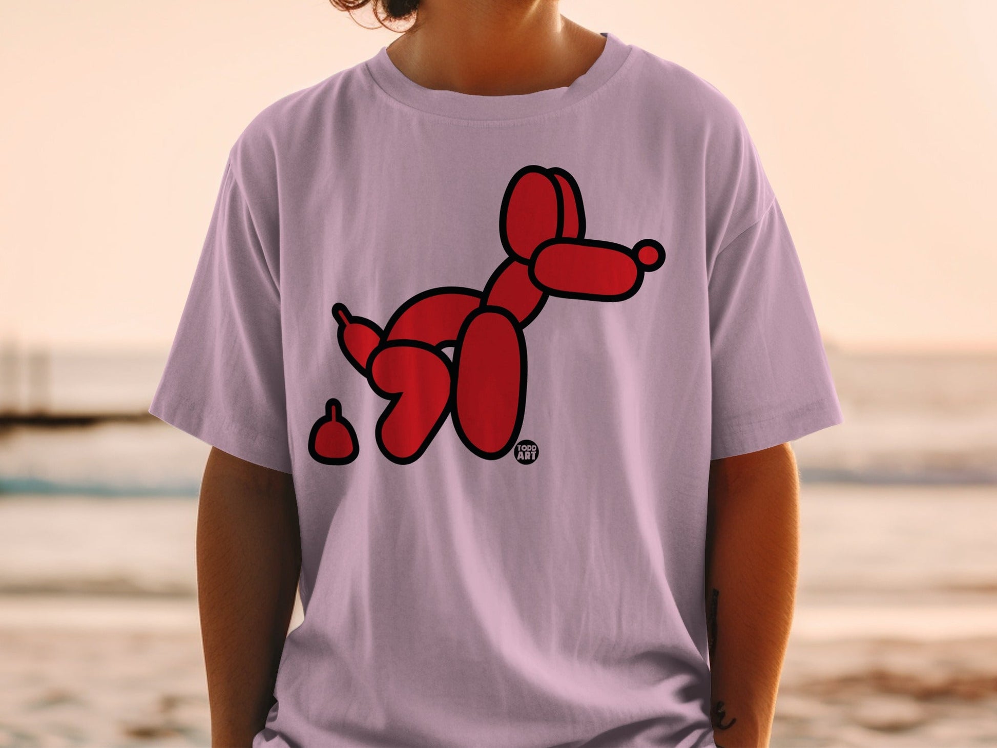 Red balloon dog with poop on light purple t-shirt.