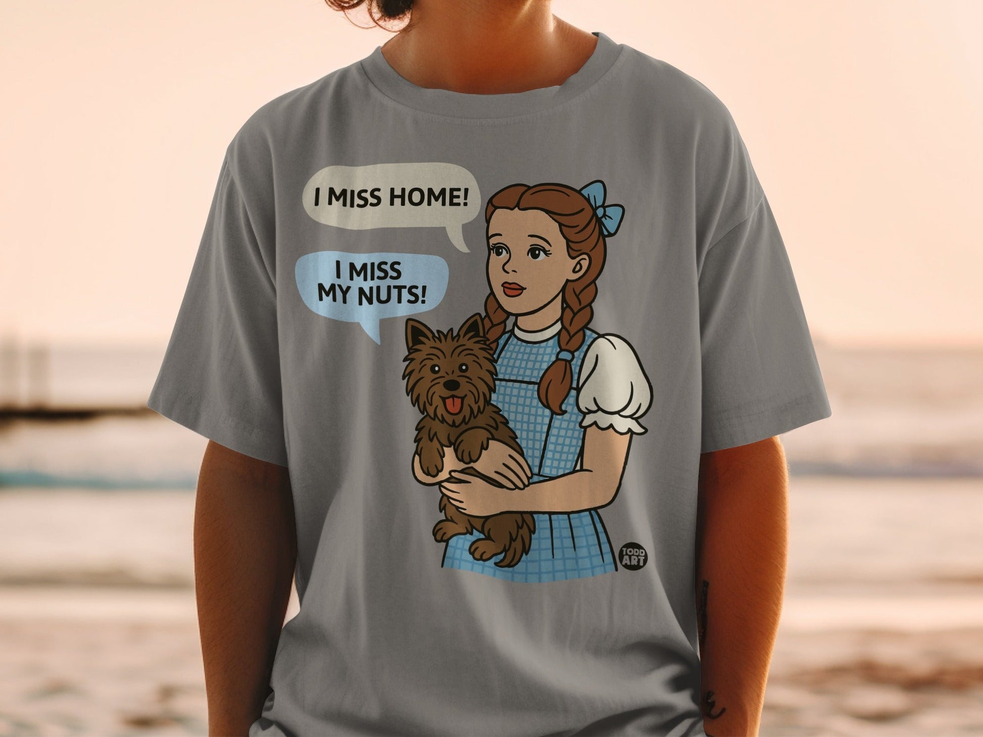Dorothy from The Wizard of Oz holding Toto, saying "I miss home!".