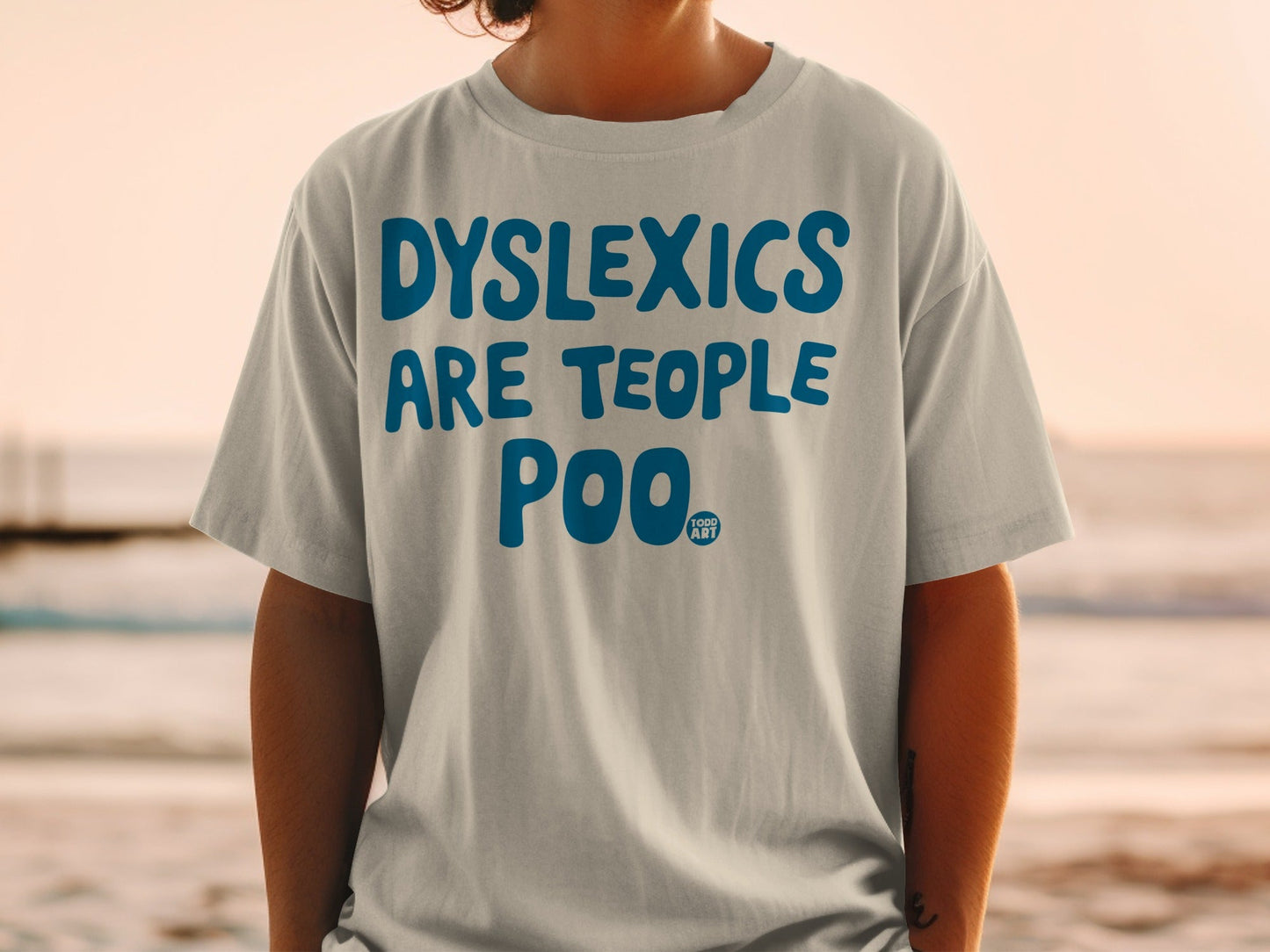 T-shirt with "DYSLEXICS ARE TEOPLE POO" and "GOOD ART" logo.