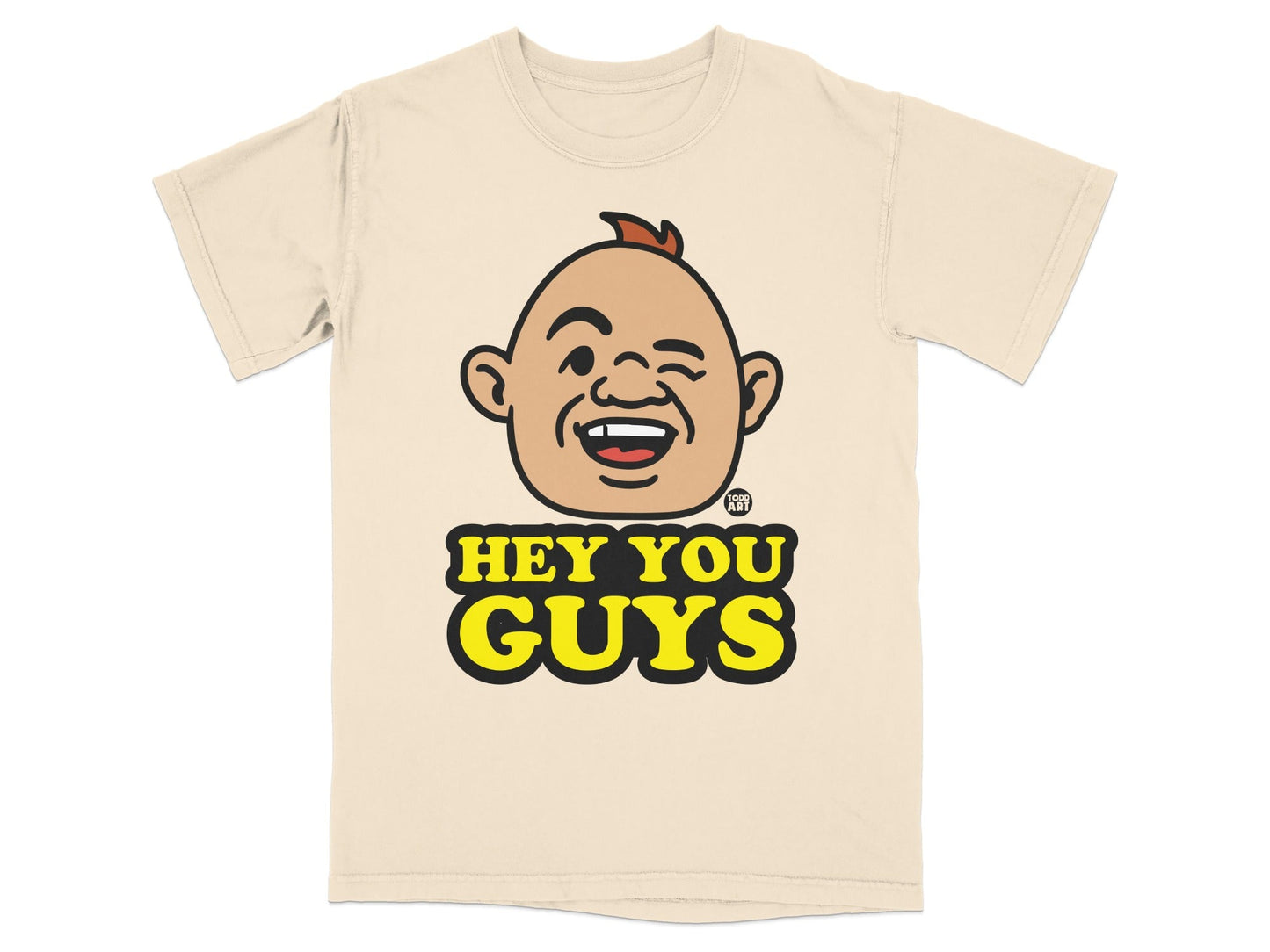 Beige t-shirt with cartoon character's head and "Hey You Guys" text.