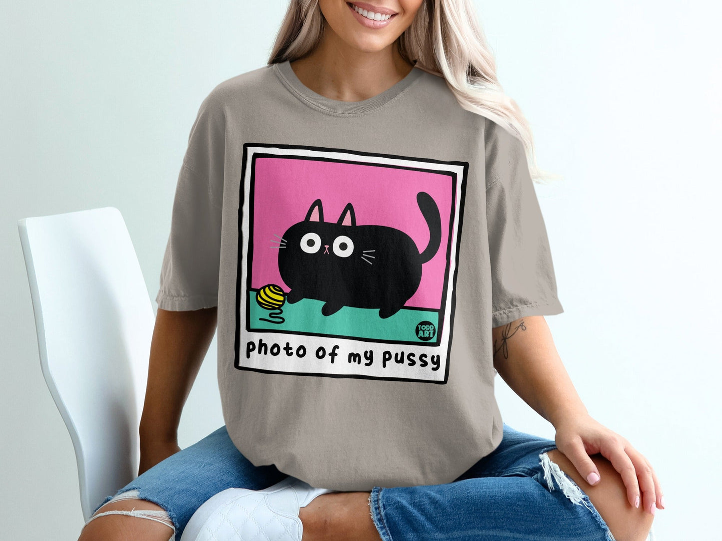 Illustration of a black cat playing with a ball of yarn on a pink background.
