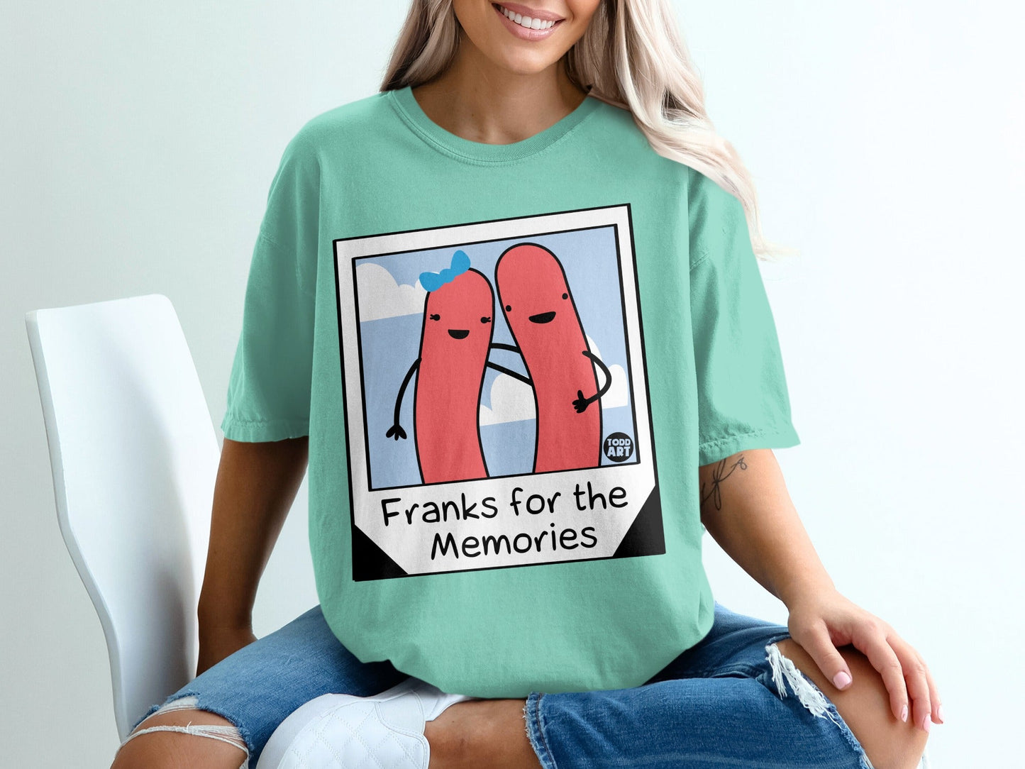 Two hot dogs embrace in a cartoon illustration with text "Franks for the Memories".