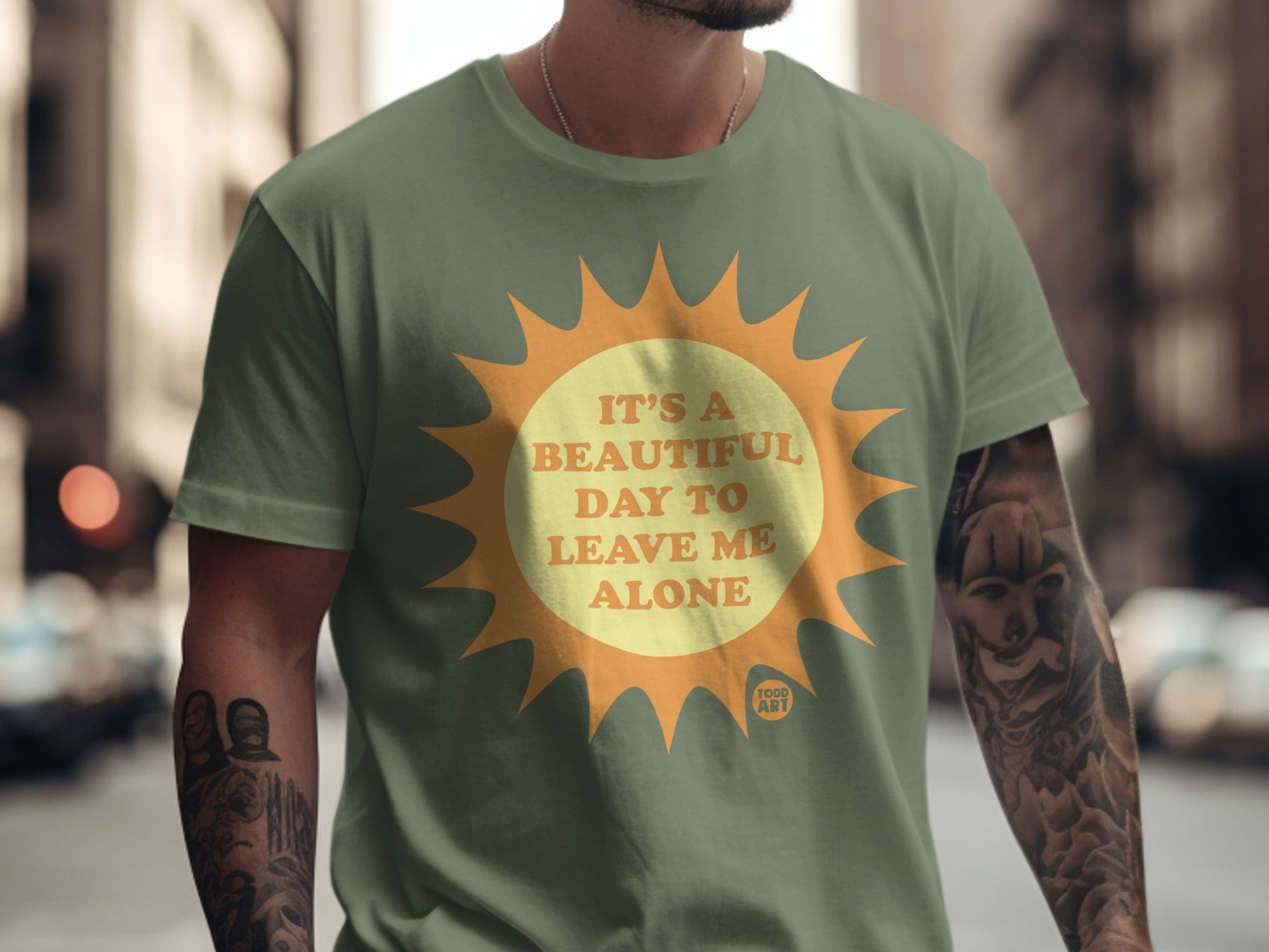 Green t-shirt with a sun graphic and text "It's a beautiful day to leave me alone."
