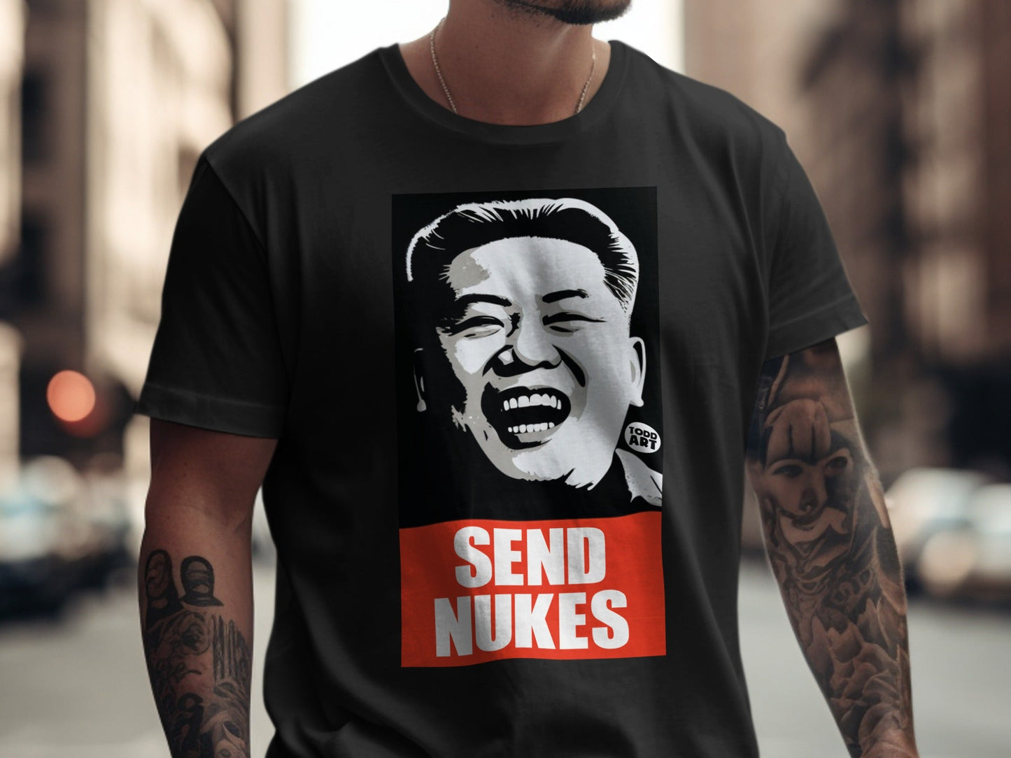Black t-shirt with a black and white portrait of Kim Jong Un and "SEND NUKES" text.